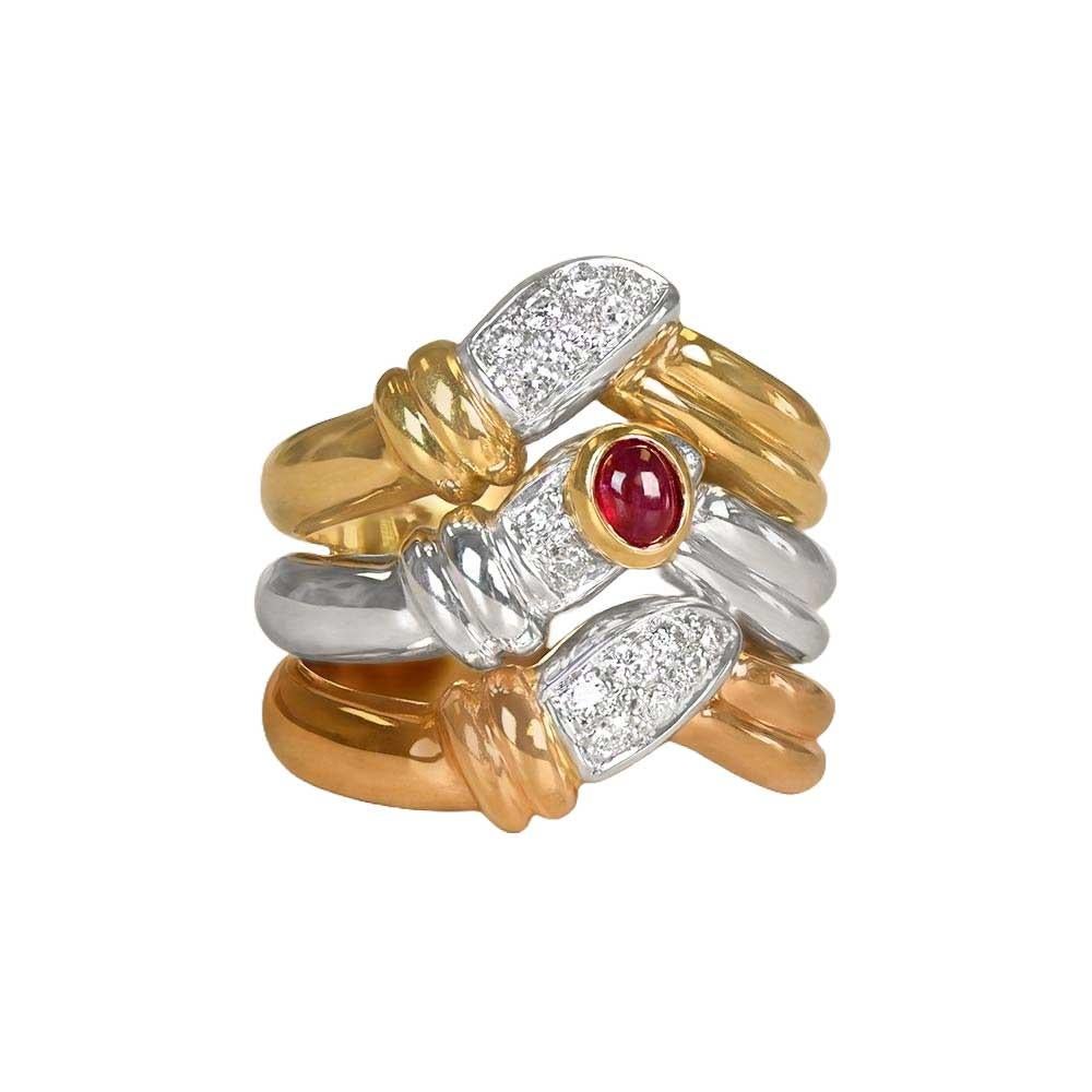An elegant tri-gold band adorned with a cabochon center ruby weighing approximately 0.28 carats. Round brilliant-cut diamonds are pave-set north and south of the ruby, adding a touch of sparkle. Crafted in 18k yellow, pink, and white gold, this