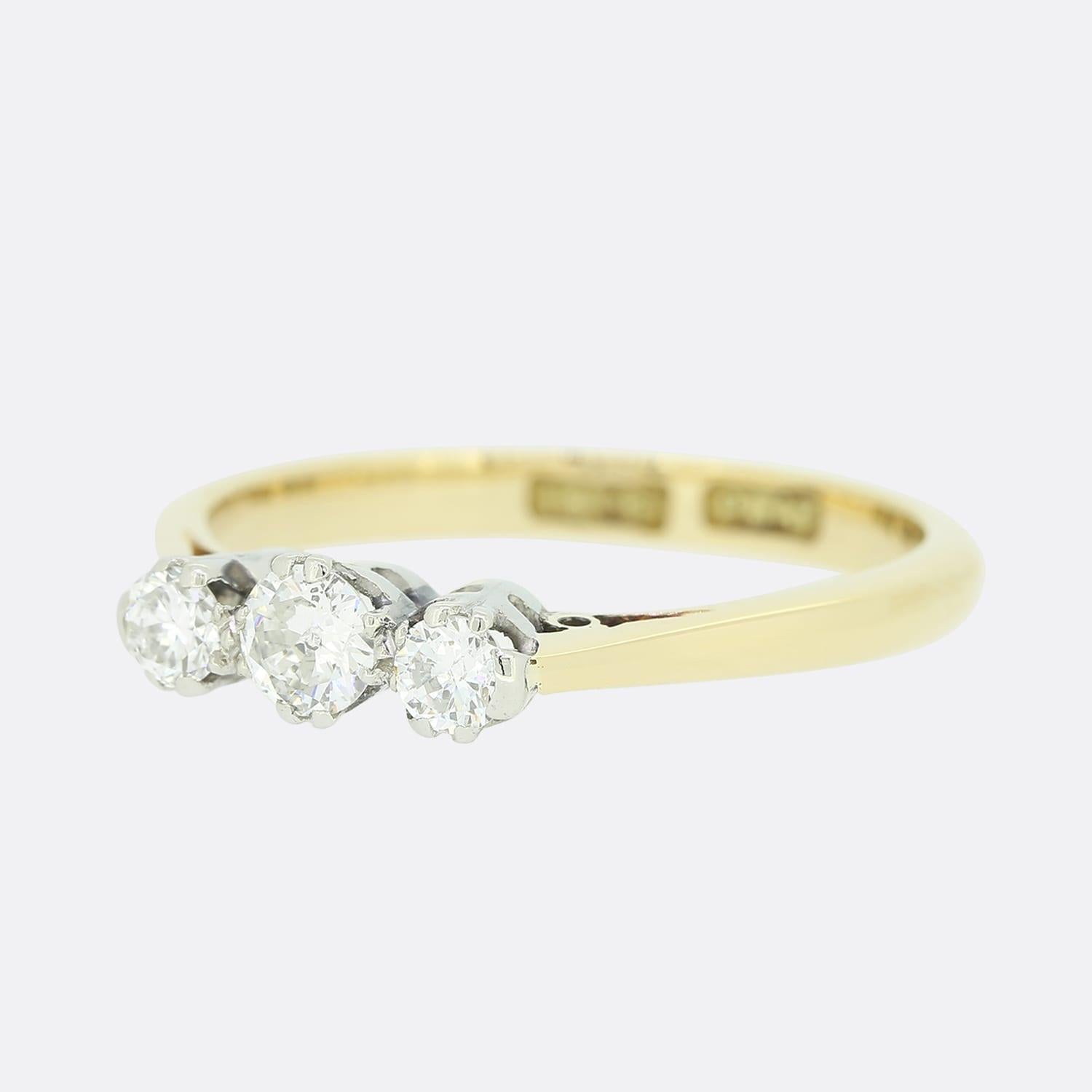 This is a vintage 18ct yellow gold diamond three-stone ring. All of the diamonds are round brilliant cuts and sit in platinum clawed mounts. The central diamond is slightly larger than the diamonds on either side.

Condition: Used (Very