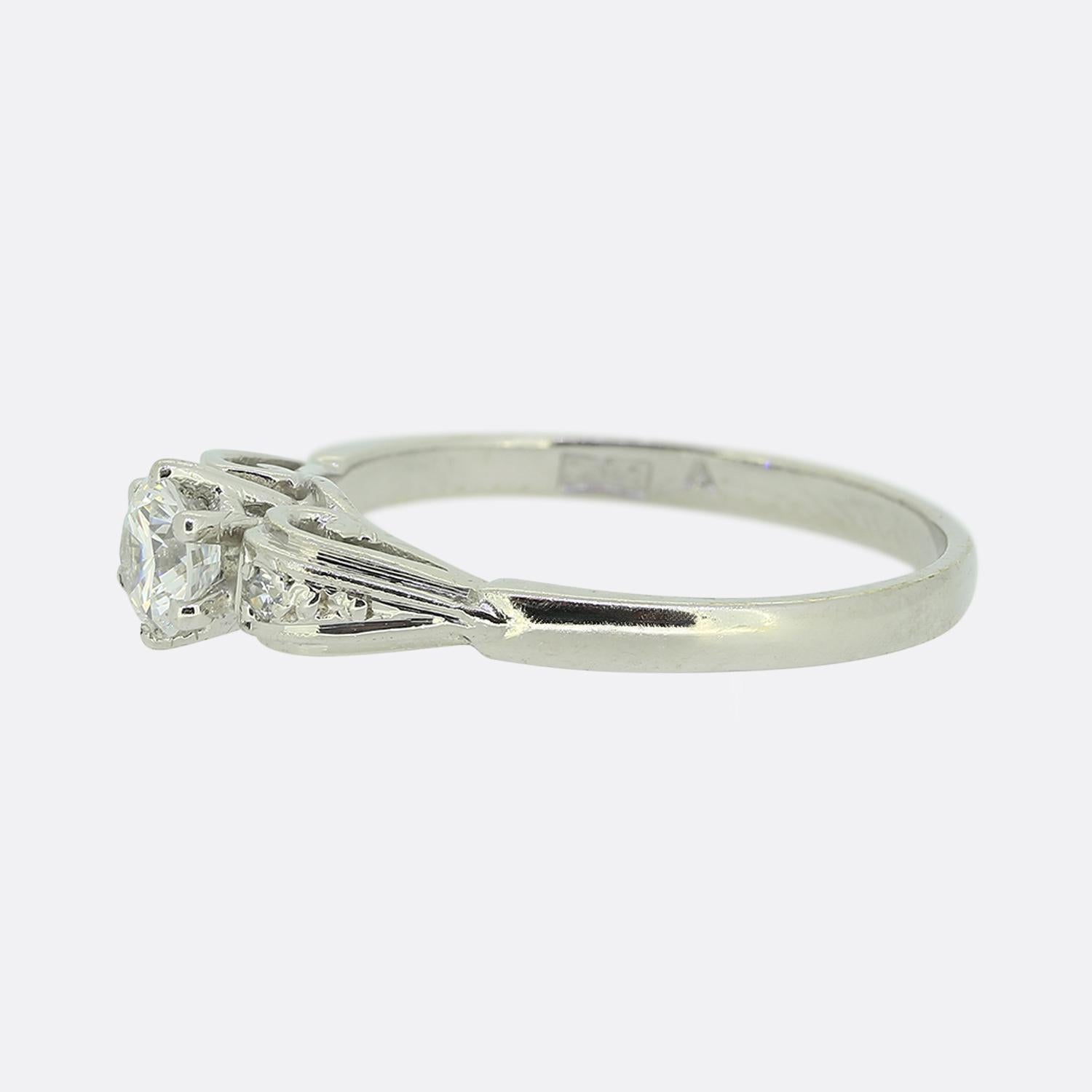 Here we have a beautiful, sparkling 9ct white gold solitaire ring featuring a single round brilliant cut diamond (0.35ct) set in a six pronged mount atop an open round gallery with a small matching diamond on each shoulder.

Condition: Used (Very