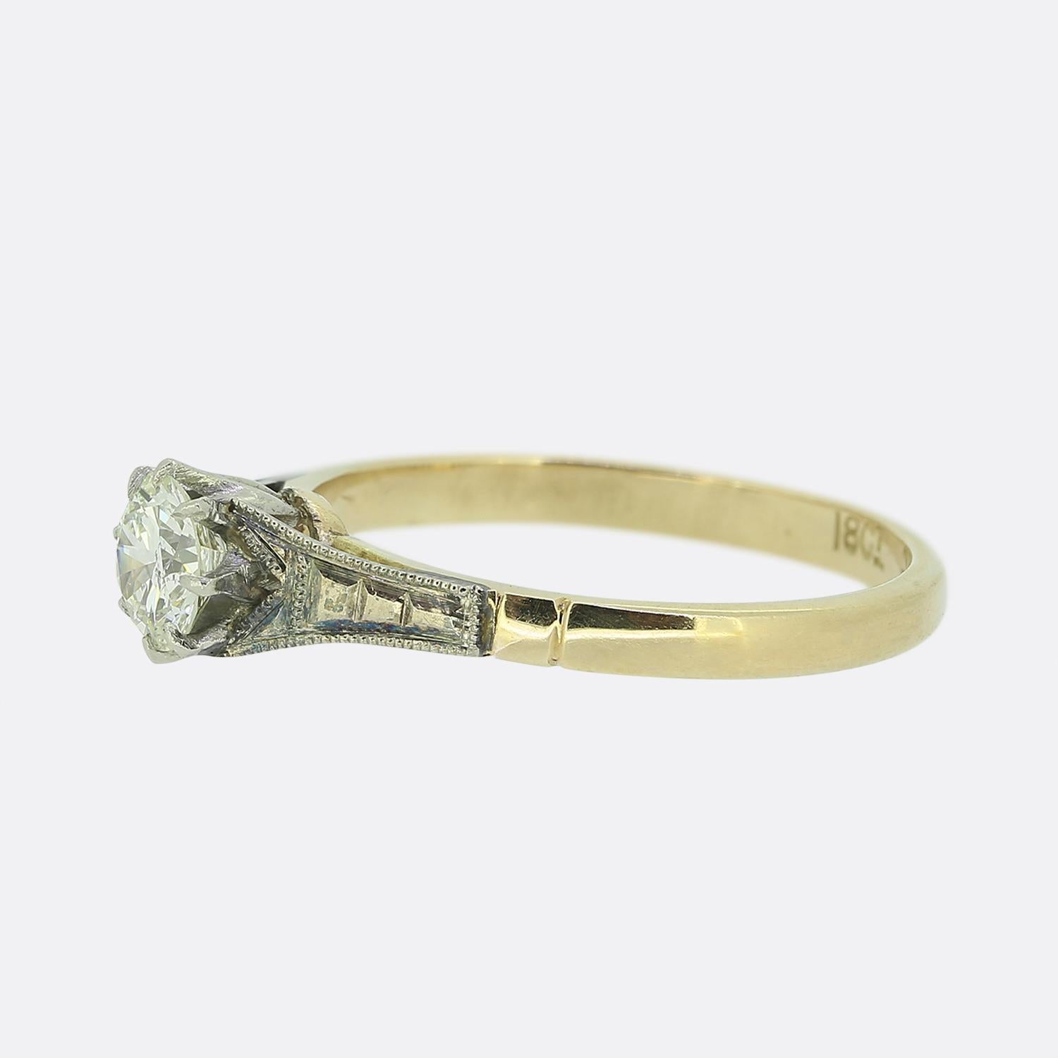 Here we have a vintage diamond solitaire ring. Set in an eight pronged platinum mount is a single round brilliant cut diamond (0.40ct) with platinum stepped shoulders neatly defined by a fine milgrain bordering before the piece is finished with an
