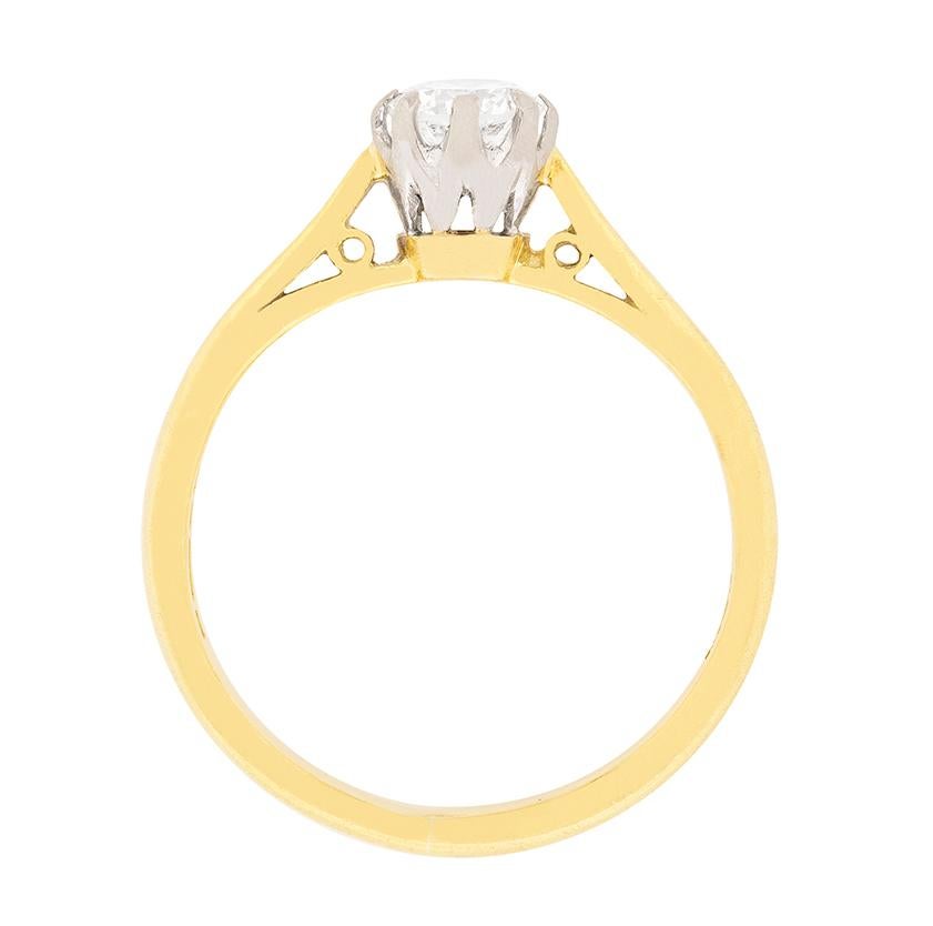 This vintage diamond solitaire engagement ring is from 1982. It centres a round brilliant cut diamond weighing 0.40 carat. The diamond is estimated G in colour and SI1 in clarity. A solid 18 carat yellow gold shank completes this retro diamond