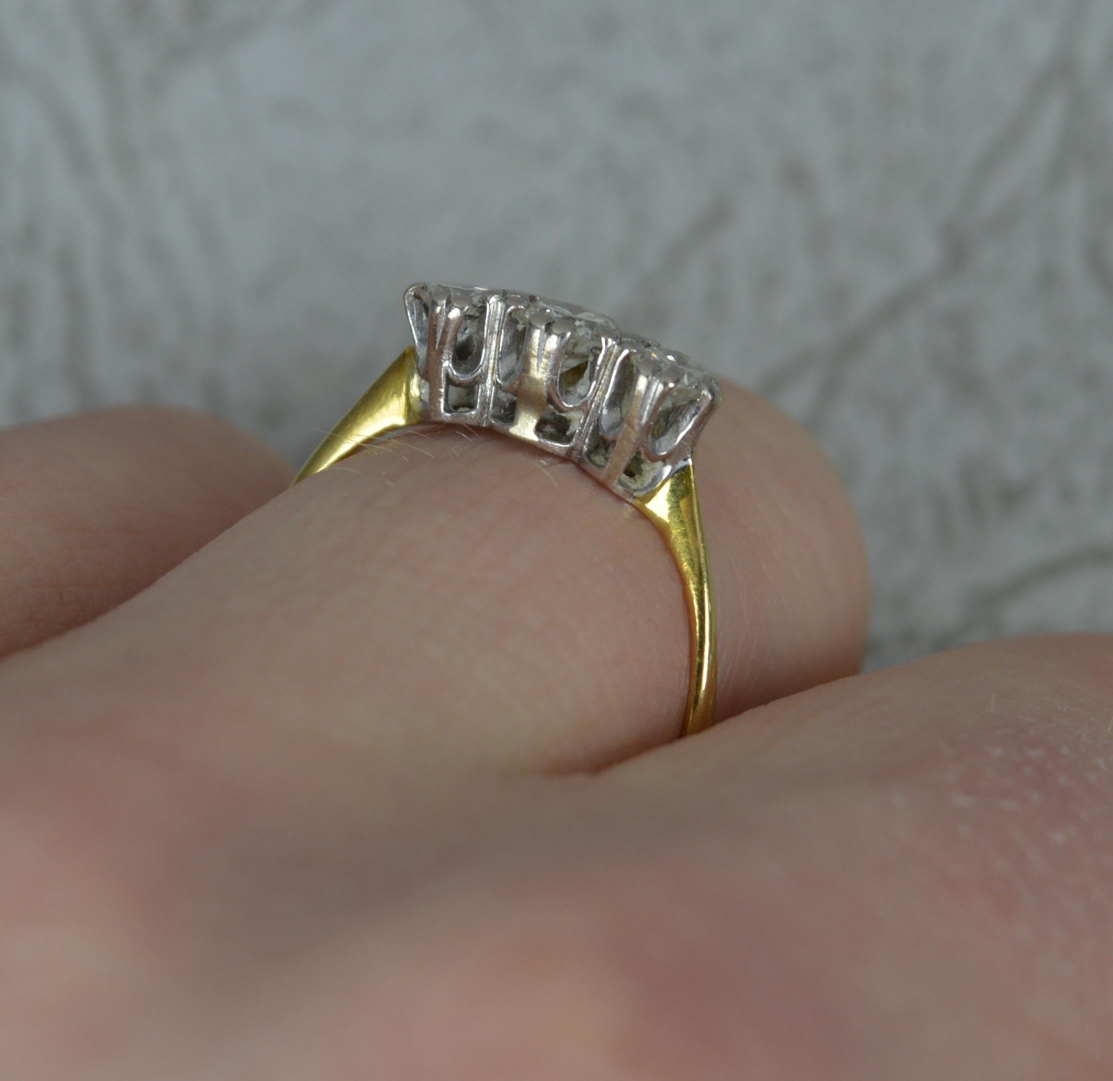 A fine natural diamond trilogy ring.
Solid 18 carat yellow gold shank with platinum head setting.
Three natural, round, transitional cut diamonds in double claw settings. 0.50 carats total. Bright and sparkly.
Vintage piece circa 1950.
12mm x 5mm