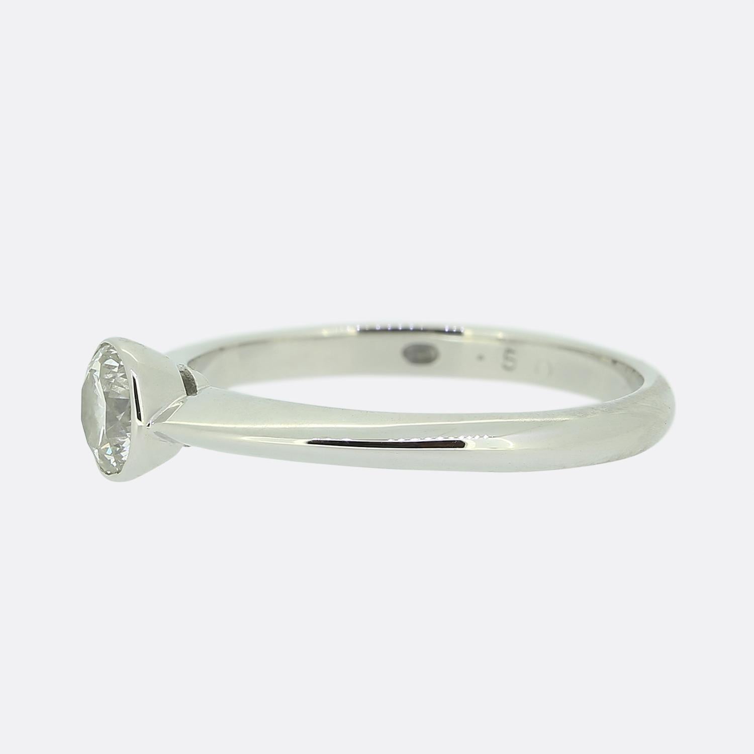 Here we have an 18ct white gold diamond solitaire ring from renowned designer Mappin & Webb. A the centre we find a single 0.50 carat round brilliant cut diamond which has been neatly bezel set atop a plain polished knife edge band.

Condition: Used