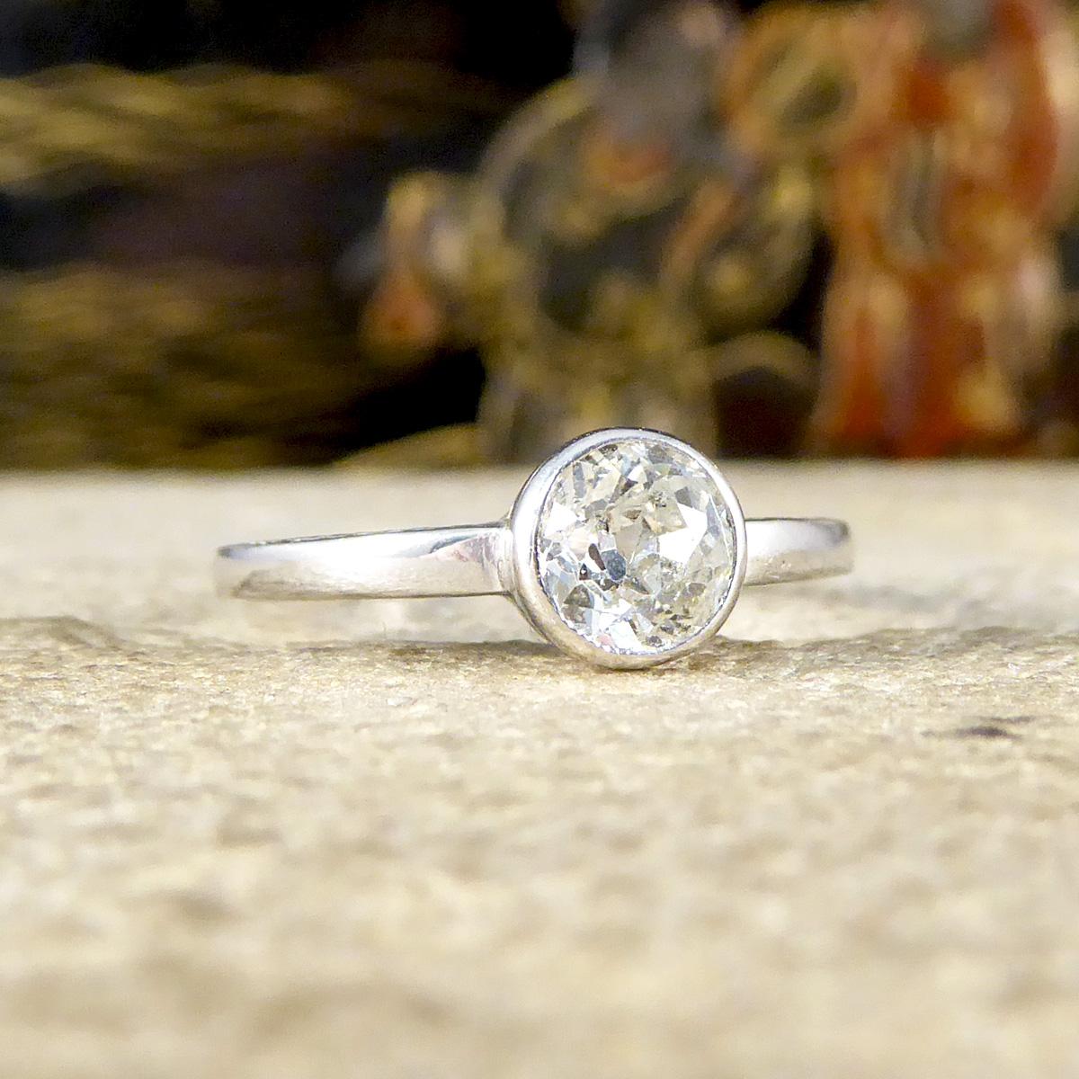 A gorgeous bright and beautiful vintage solitaire ring. Featuring is a 0.50ct Old European Cut Diamond in a rub over collar setting with little inclusions running through the stone giving it so much character. From head on it looks to be plain and