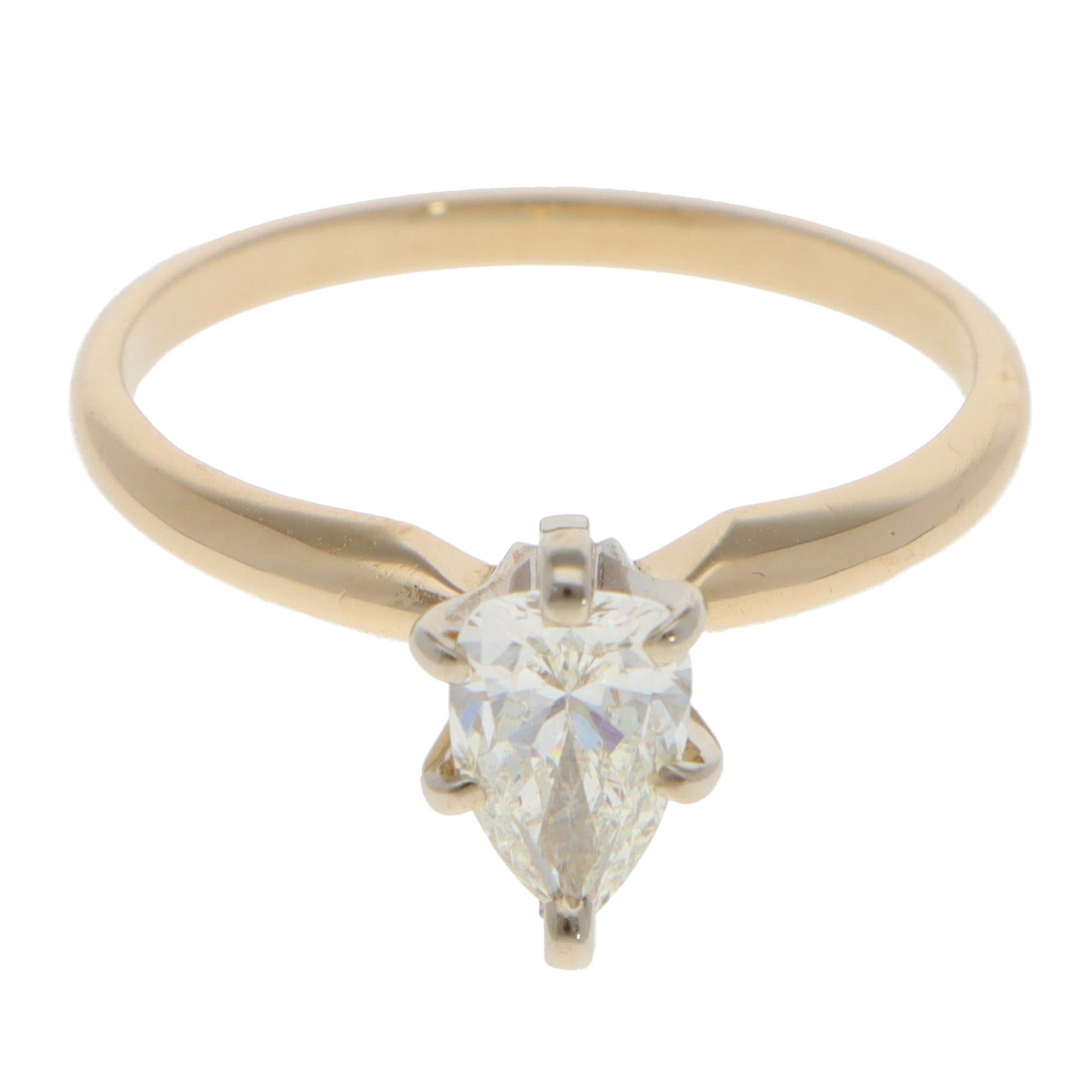 Un classico anello solitario vintage con diamante a forma di pera incastonato in oro giallo e bianco 14k.

L'anello presenta unicamente un bellissimo diamante a forma di pera. Il diamante è incastonato a sei griffe al centro di un'incastonatura a