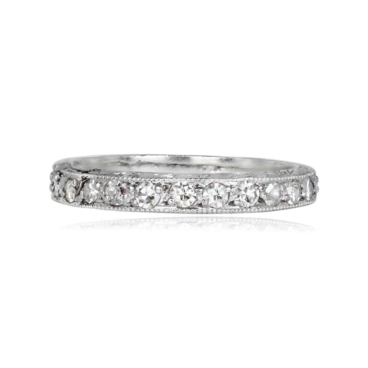A vintage platinum eternity band showcasing about 0.58 carats of J-K color, VS2 clarity single-cut diamonds. The band features channel-setting and intricate hand engravings along the side. Handcrafted circa 1955.

Ring Size: 6.5 US, Resizable
Color: