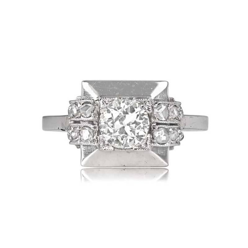 A vintage geometric engagement ring, handcrafted in platinum and showcasing a 0.60-carat old European cut diamond. The center diamond is K color and SI2 clarity, set in box prongs. Rows of east-west oriented rose-cut diamonds flank the center stone.