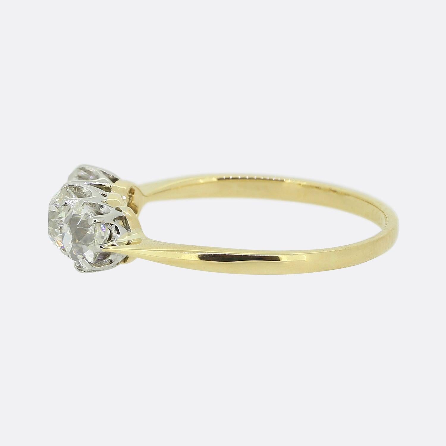 Here we have a charming three-stone diamond ring. This vintage piece has been crafted from 18ct yellow gold and showcases a trio of round faceted old cut diamonds in a single line formation. Each stone is well matched in term of size, colour,