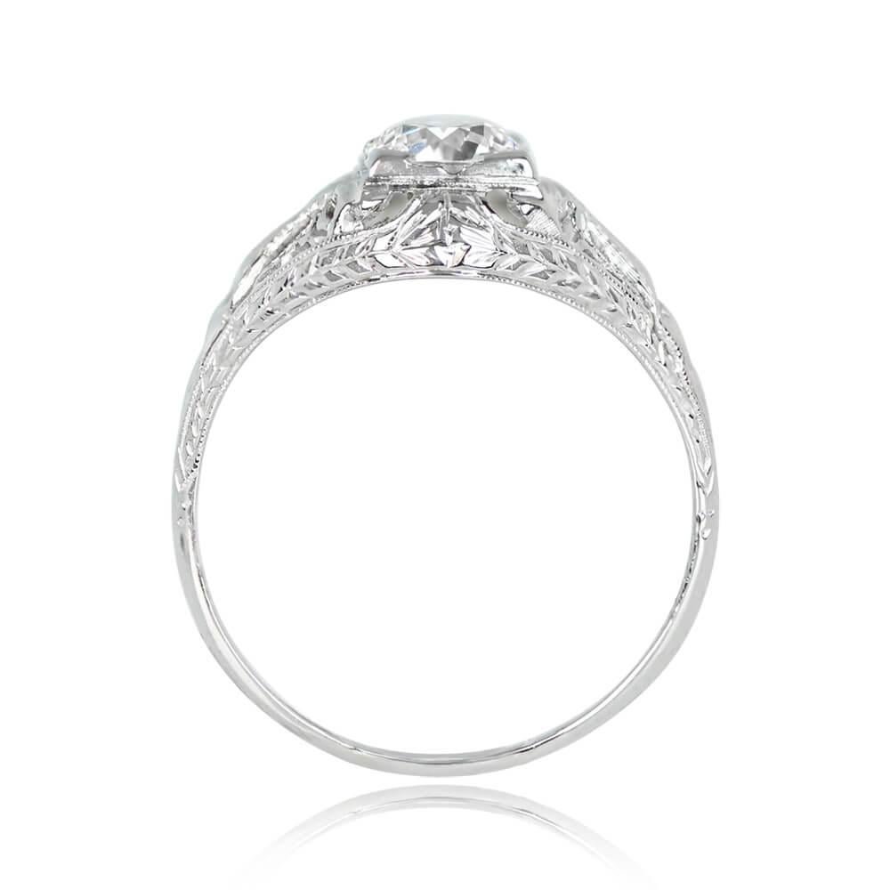 A vintage engagement ring features a 0.71-carat old European cut diamond in box prongs, J color, and VS1 clarity. The shoulders are adorned with a geometric diamond-set bow motif. Crafted in 18k white gold, the mounting showcases fine milgrain and