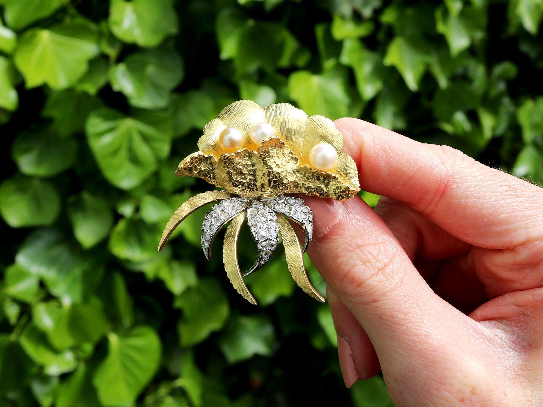 A stunning, fine and impressive 0.75 carat diamond and cultured pearl, 18 karat yellow gold and 18 karat white gold set brooch in the form of an oyster shell; part of our diverse antique jewellery and estate jewelry collections.

This stunning, fine