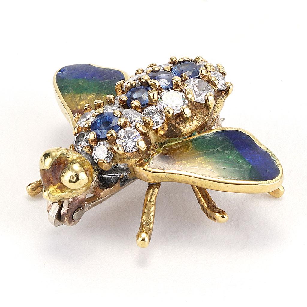This pin is made of 18k yellow gold and weighs 3.10 DWT (approx. 4.82 grams). It contains 15 round G color, SI clarity diamonds weighing 0.50 CTTW and 4 round blue sapphires weighing 0.30 CTTW. Dimensions: 0.75