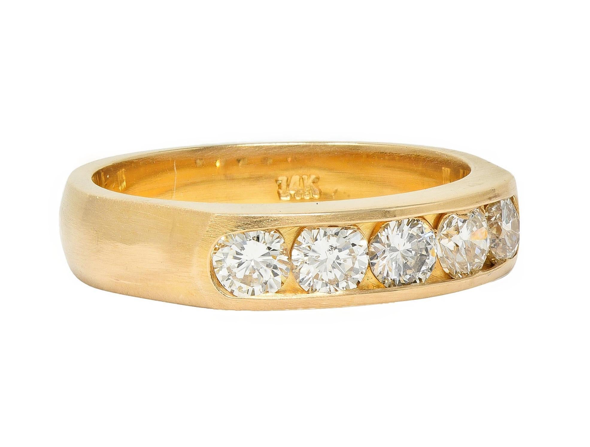 Centering five transitional cut diamonds channel set to front
Weighing approximately 0.80 carat total 
G color with VS2 clarity - flanked by flared shoulders
With a brushed matte finish 
Stamped for 14 karat gold 
Circa: 1960s
Ring size: 6 and
