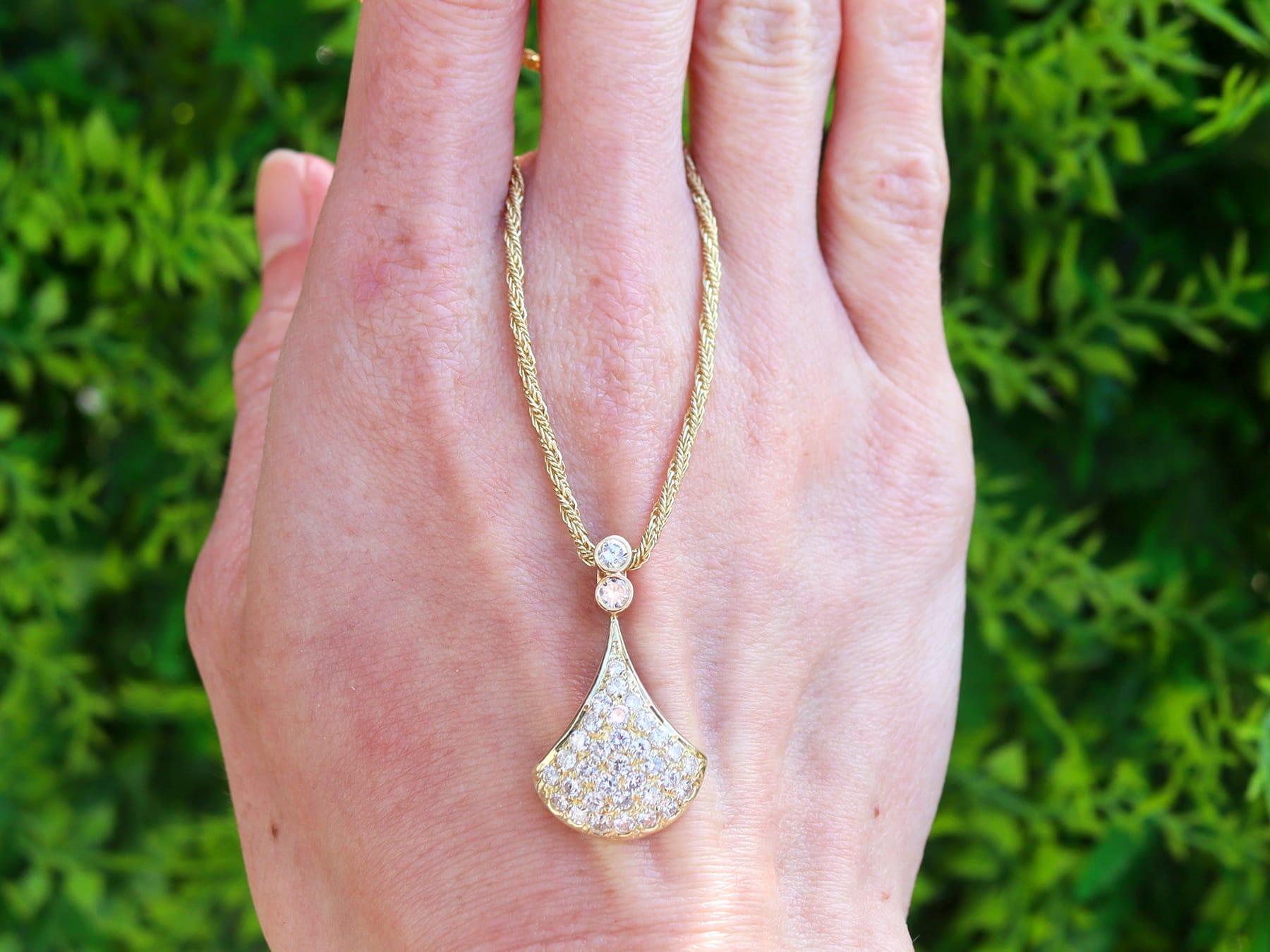 A stunning, fine and impressive vintage 0.85 carat multi diamond and 14 karat yellow gold pendant; part of our diverse vintage jewelry collections.

This stunning, fine and impressive diamond pendant has been crafted in 14k yellow gold.

The domed,