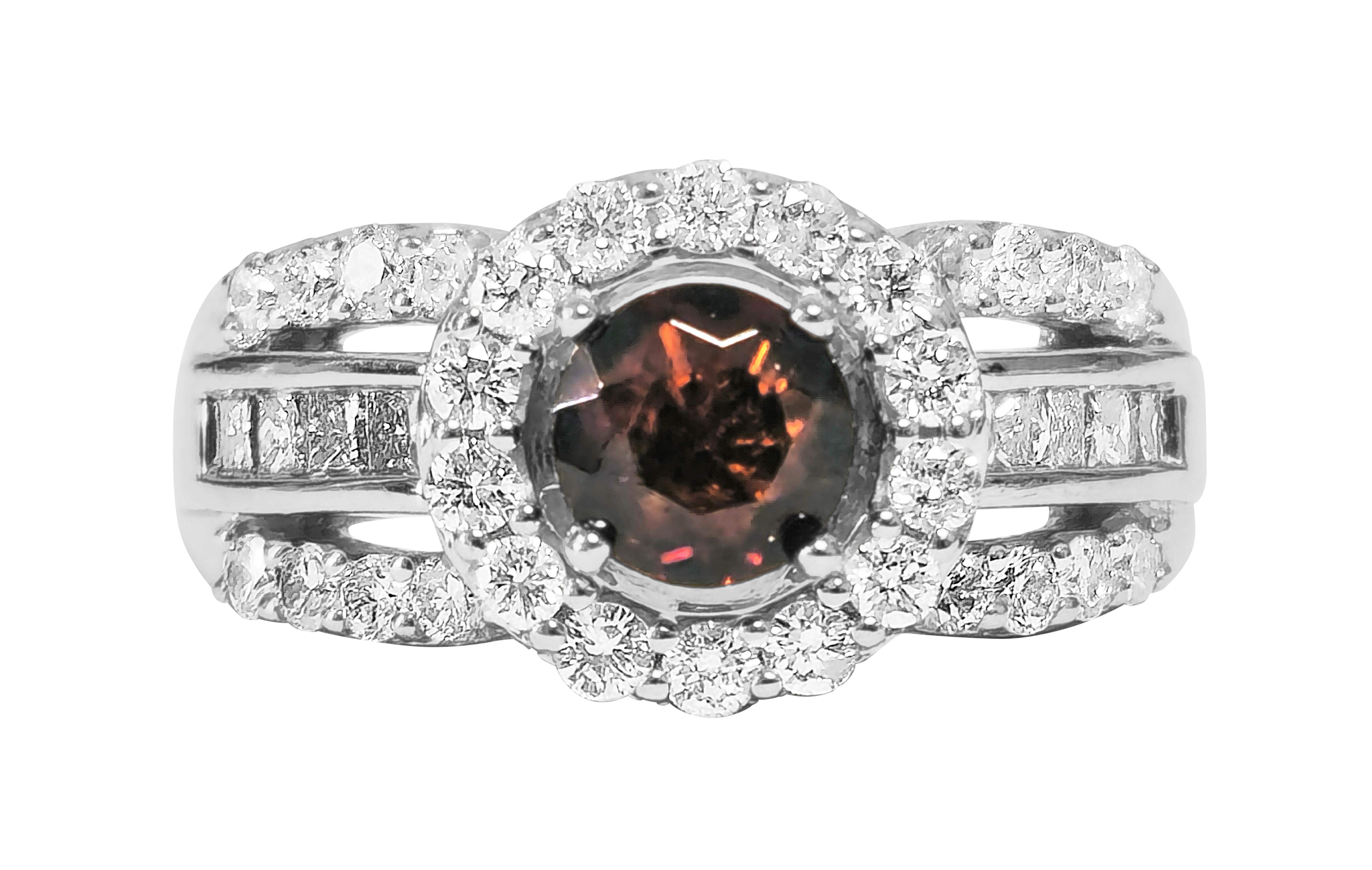 Fashioned from elegant 14K white gold, this captivating ring features a total of 1.17 carats of round brilliant cut diamonds, boasting VS clarity and F-G color. Adorned with a stunning 0.85 carat round garnet, the ring exudes sophistication and