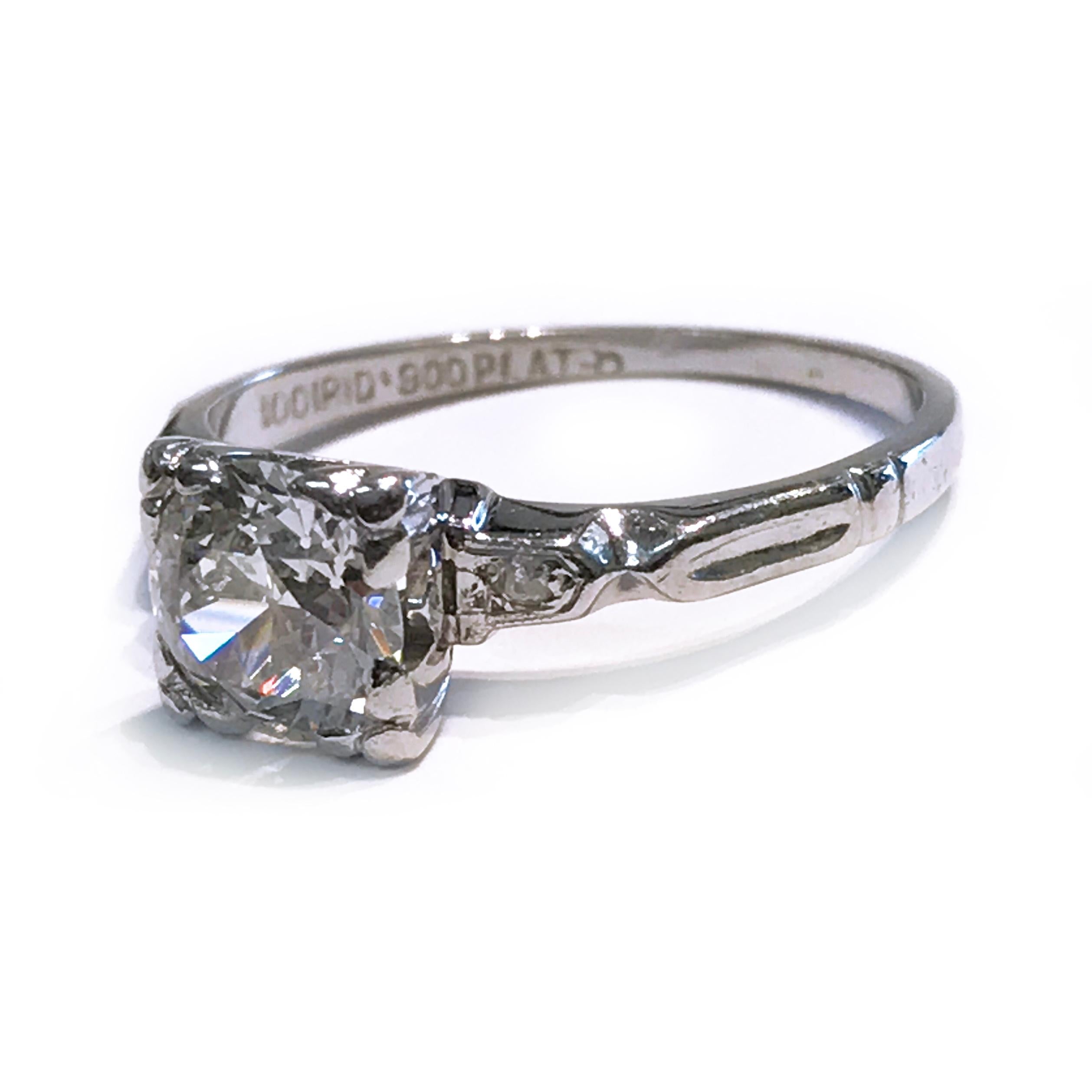 Vintage 1 Carat Diamond Platinum Engagement Ring. The Center Diamond measures 6.5mm x 6.64mm x 3.55mm and has a carat weight of 1.00 carat. The Diamond is VS2 (G.I.A.) in clarity and G-H (G.I.A.) in color. Two accent diamonds flank either side of