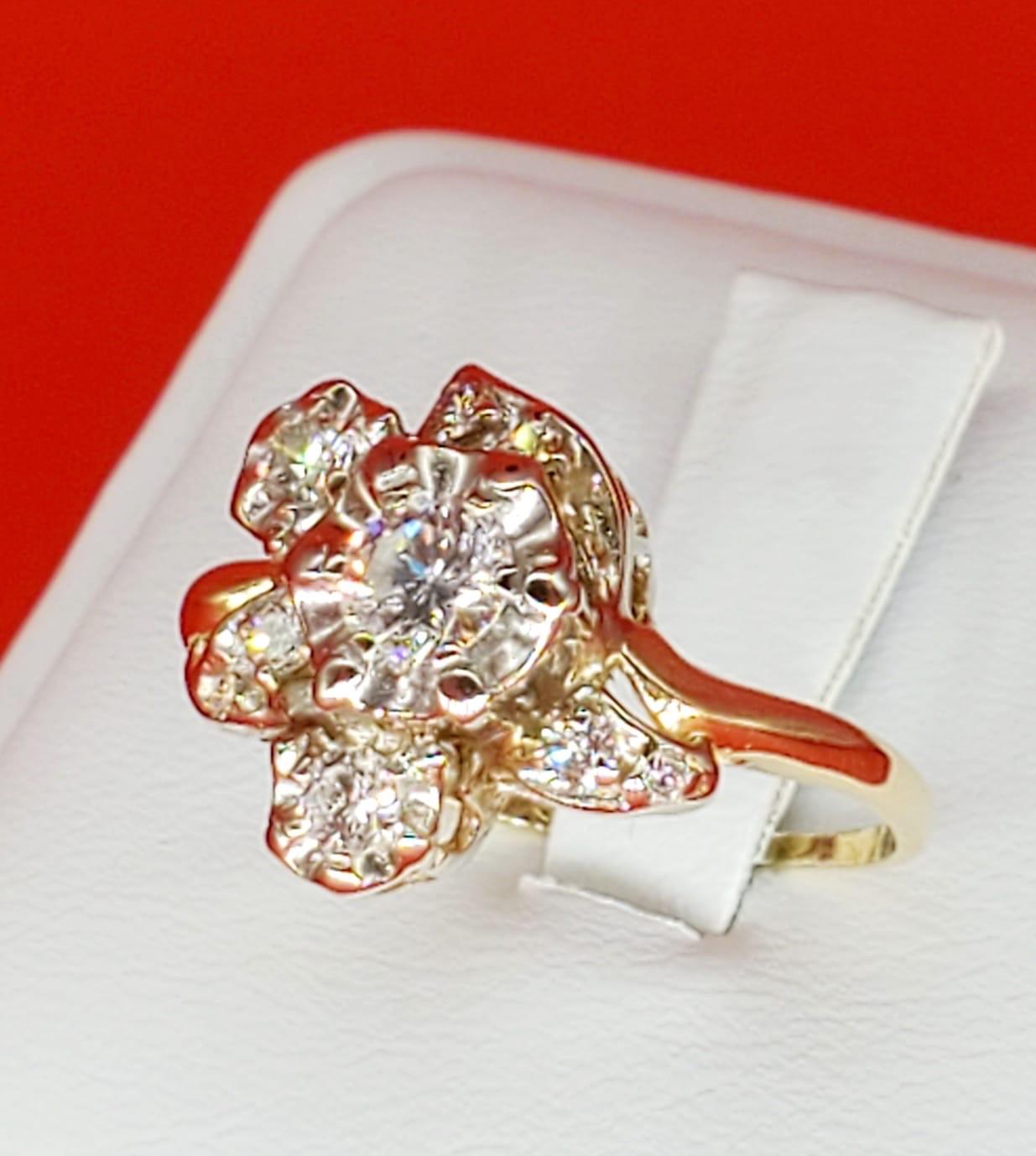 Vintage 1 Carat Diamonds Flower Cluster Ring. The ring is well assembled and crafted with two-tone 18k gold making the diamonds stand out from every angle of the ring. There is a an approx total of 1 carat in diamonds that are clean and white. The