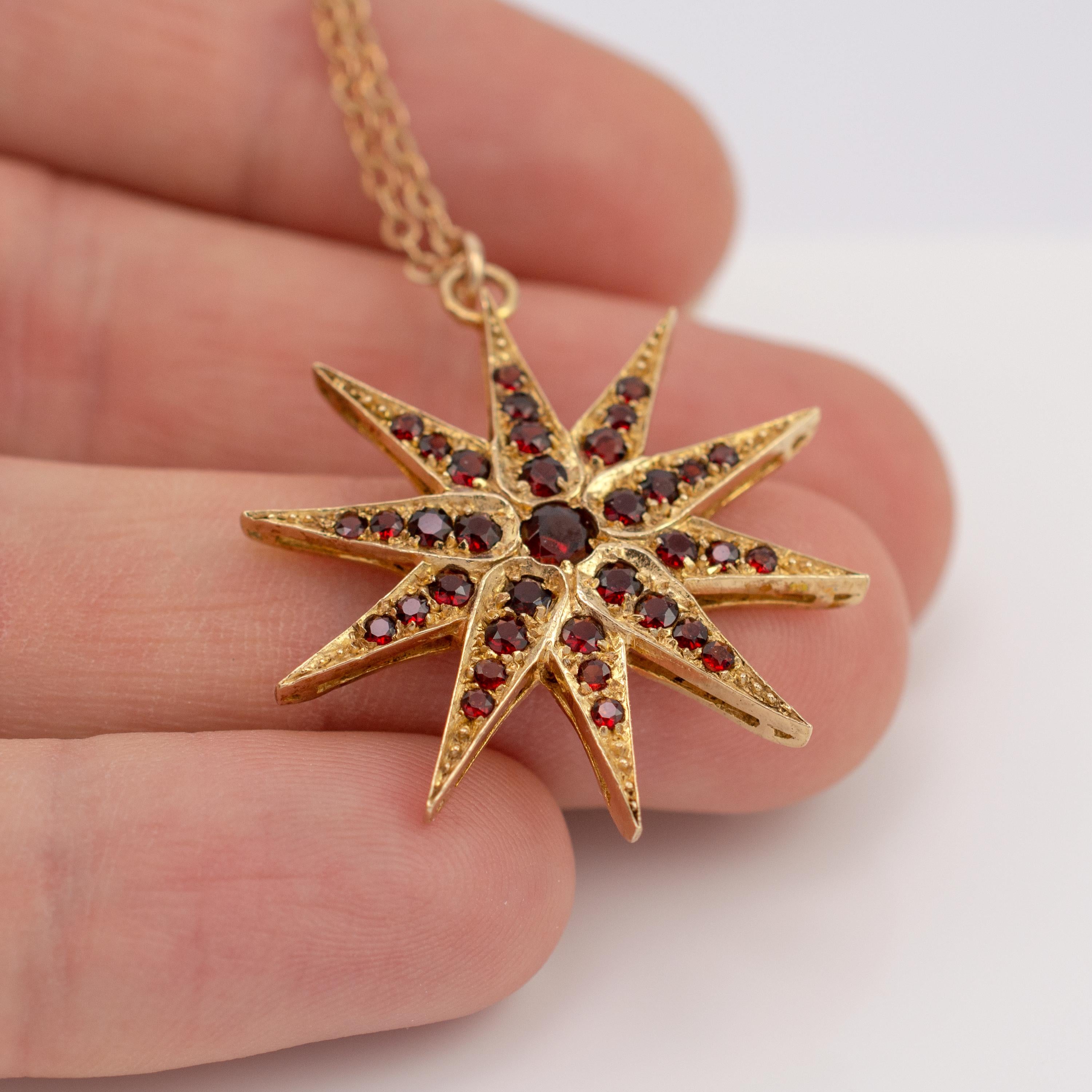 A striking garnet starburst pendant in gold hallmarked and dated London 1972.

The Victorian-style star pendant, measuring a substantial 3.2 centimeters in diameter, is bejeweled with graduated round cut garnets totaling approx 0.90 cts and a 0.15