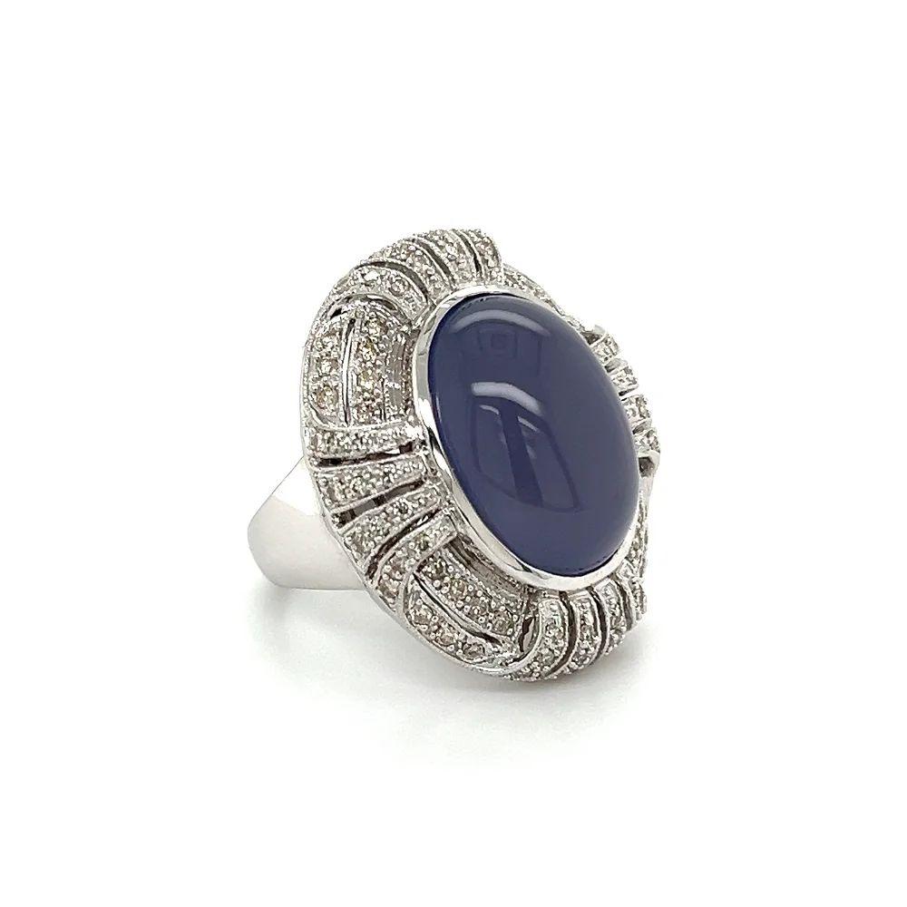 Simply Beautiful! Magnificent Blue Chalcedony and Diamond Gold Cocktail Ring. Centering a 10 Carat Cabochon Blue Chalcedony. Surrounded by Brilliant-cut Diamonds, weighing approx. 1.00tcw. Artistically Hand crafted in 18K White Gold; Ring size 7.25,