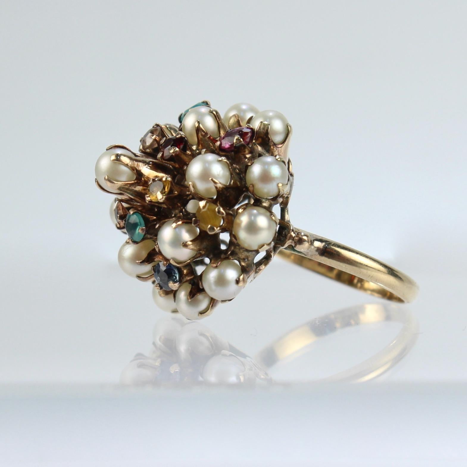 A very fine vintage 10k gold, cultured pearl & gemstone Princess Harem ring.

Set with 12 small round cut gemstones including emeralds, amethysts, citrines and 17 small round, white pearls.

Simply a great cocktail ring!

Date:
20th Century

Overall
