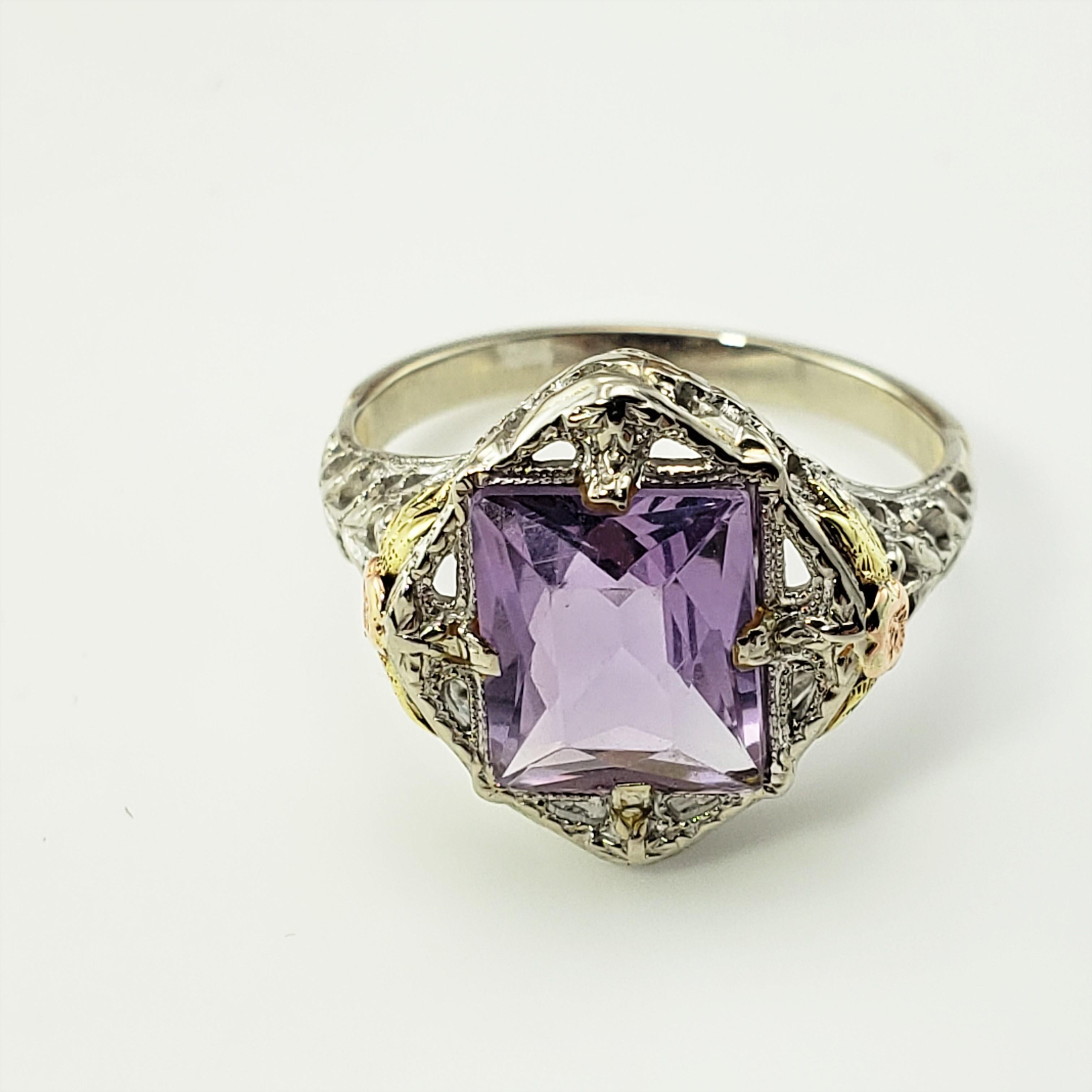 Vintage 10 Karat White, Rose and Yellow Gold Amethyst Ring Size 4.25 GAI Certified-

This lovely ring features one rectangular amethyst stone (7 mm x 7 mm) set in beautifully detailed 10K white gold. Accented with yellow and rose gold flowers.