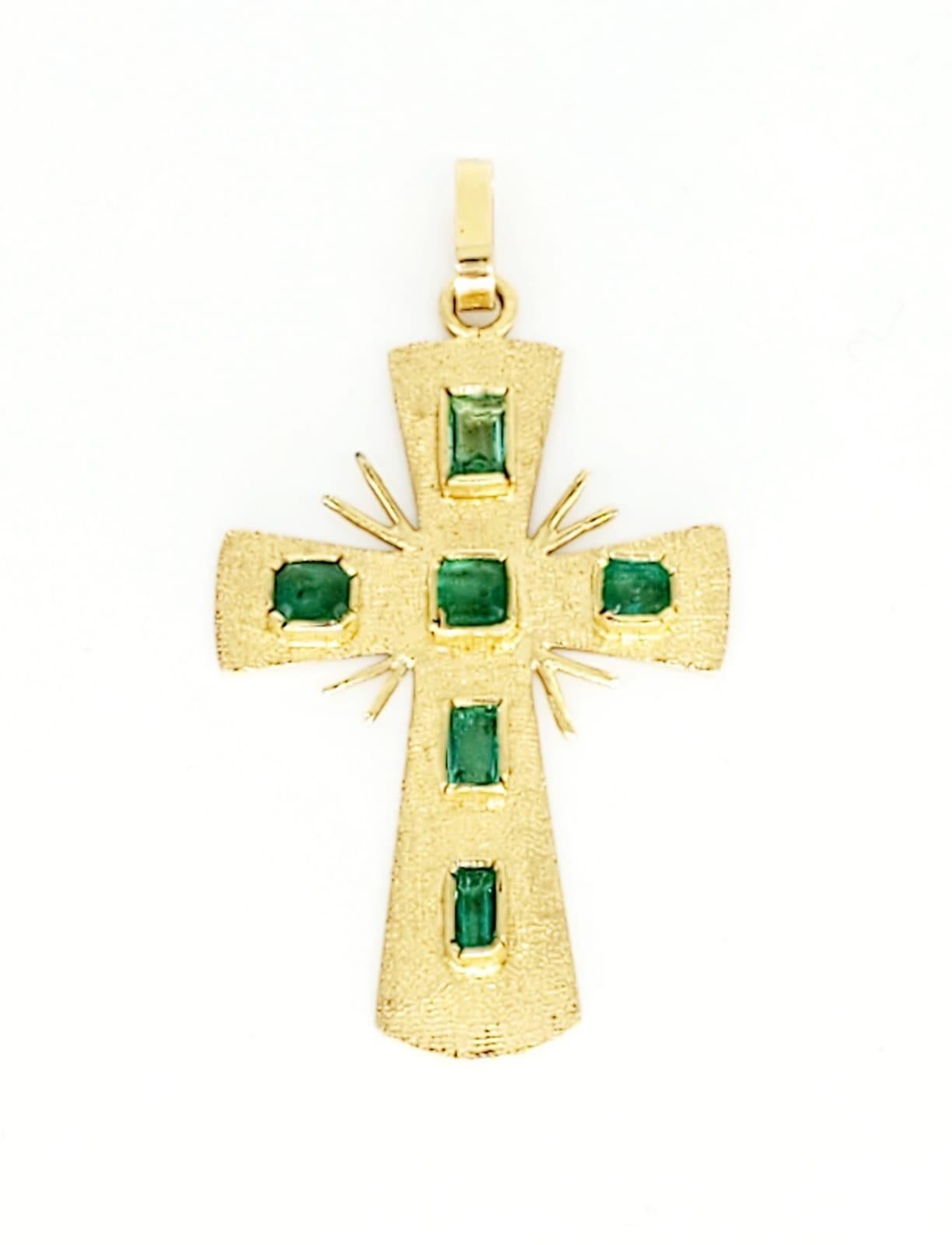 gold cross with emeralds