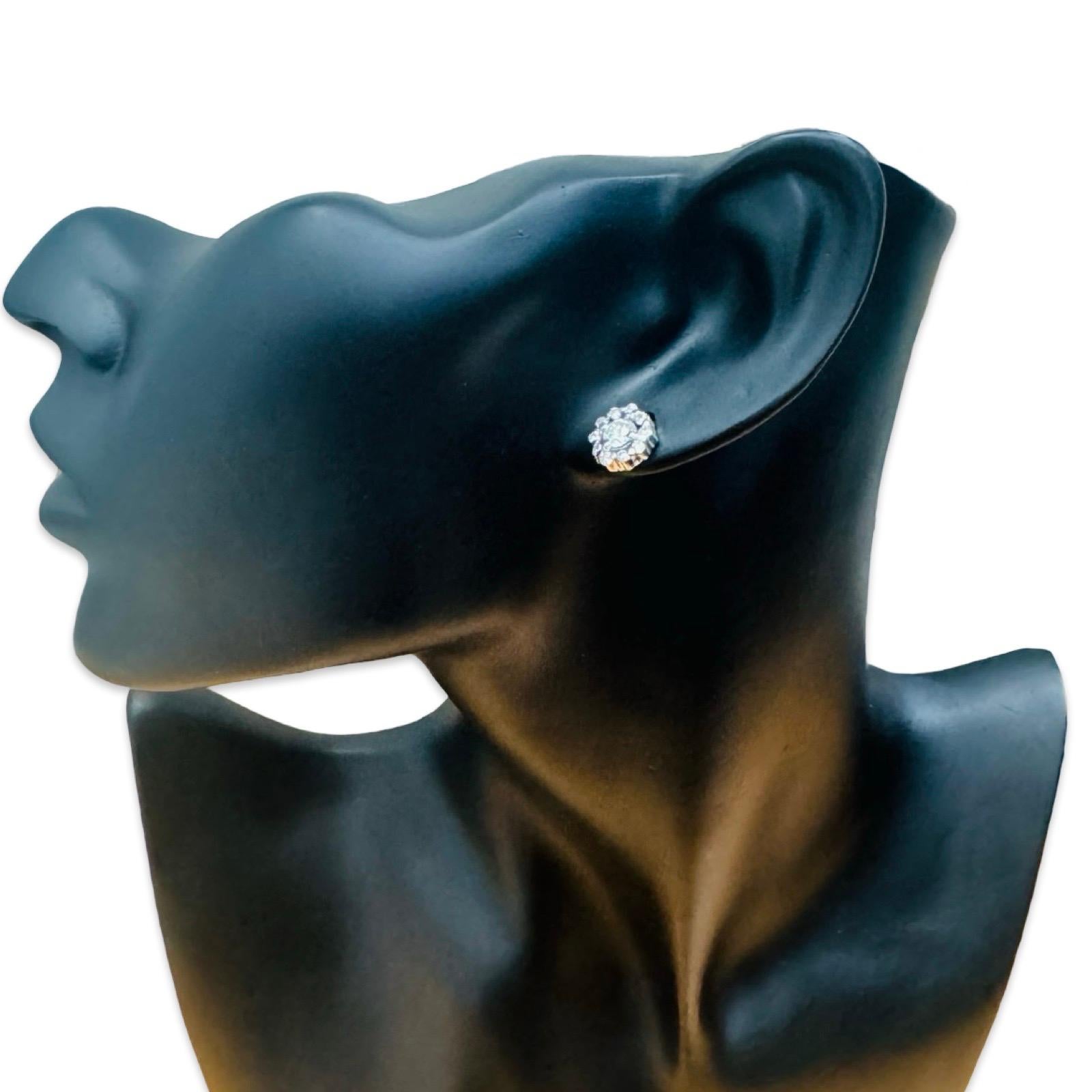 This exquisite pair of earrings features two stunning round-cut diamonds at the center, each weighing 0.40 carats. Surrounding the center stones are 20 sparkling round diamonds (10 per earring), each weighing 0.01 carat, bringing the total diamond