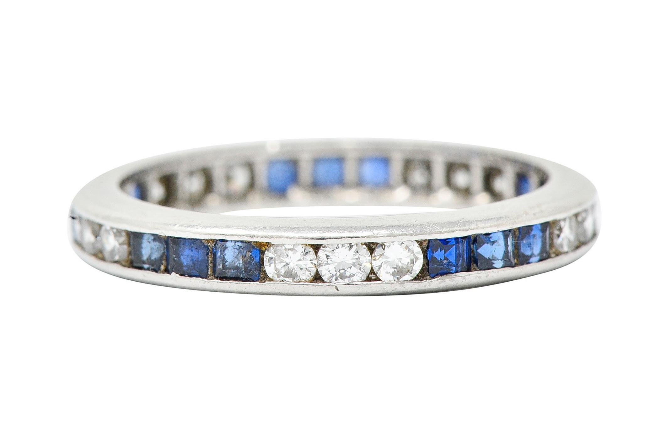 Eternity band ring is channel set fully around by sapphires and diamonds, alternating

Square cut sapphires are a very well matched royal blue and weigh in total approximately 0.50 carat

Round brilliant cut diamonds weigh in total approximately