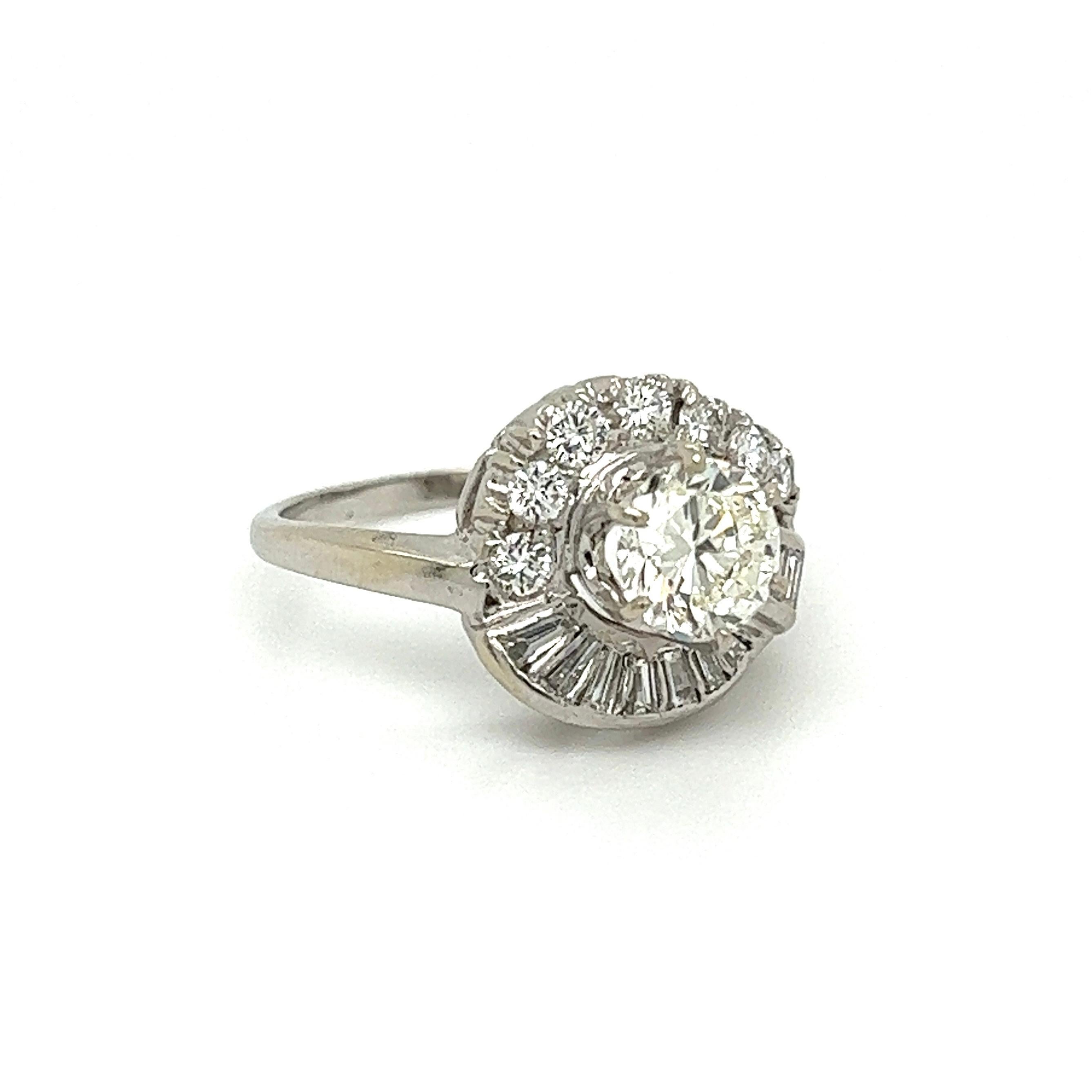 Simply Beautiful! Finely detailed Retro Diamond Swirl Design Gold Cocktail Ring. Centering a securely nestled Hand set 1.01 Carat Transitional RBC Diamond, measuring 6.50mm, weighing approx. 1.01 Carat. Estimated grade J-VS1. Surrounded by Baguette