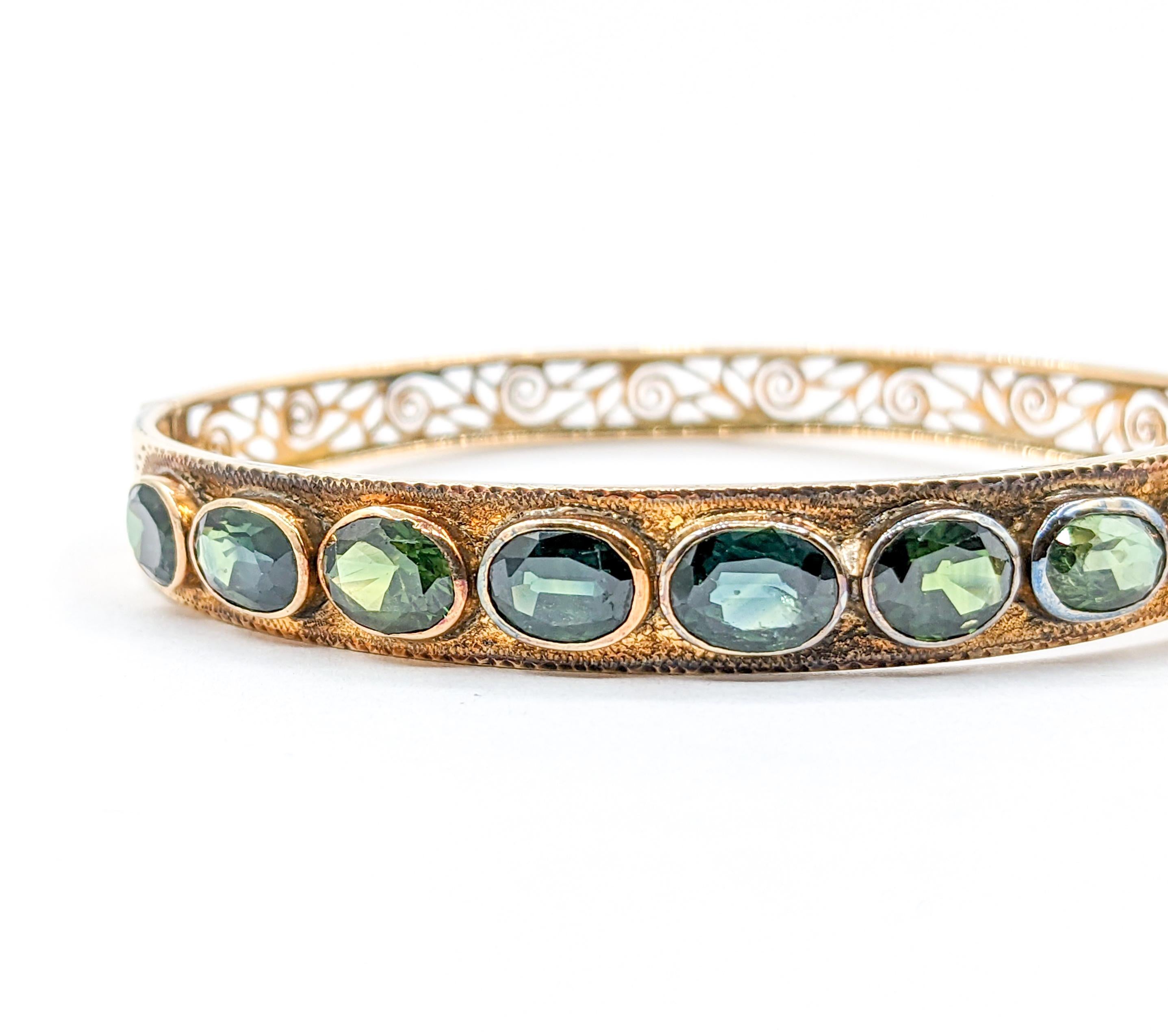 Fabulous 18k 10.1ctw Oval Teal Sapphire Bangle Bracelet

Introducing this stunning vintage sapphire bracelet, a masterful creation in the world of fine jewelry. Fashioned in exquisite 18k yellow gold, it is adorned with an impressive 10.1ctw of oval