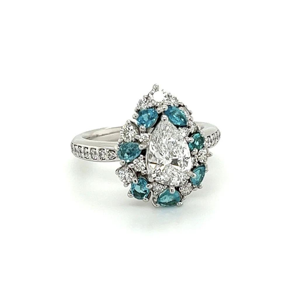 Simply Beautiful! Finely detailed Exquisite Pear Diamond and Paraiba Platinum Cocktail Ring. Centering a securely nestled Hand set 1.02 Carat D-SI2 Pear Diamond IGI Surrounded by Paraiba Tourmaline Gemstones, weighing approx. 0.52tcw and Round