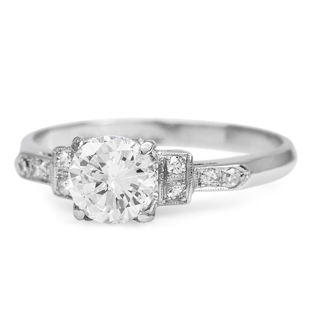 An exquisite Round Cut Engagement Ring with a Geometric style.

Bringing the beauty of the Art Deco style is crafted in platinum.

with an approximate total weight of 3.4 grams.

The center is adorned by a Genuine Round Diamond cut, Prong-set, with