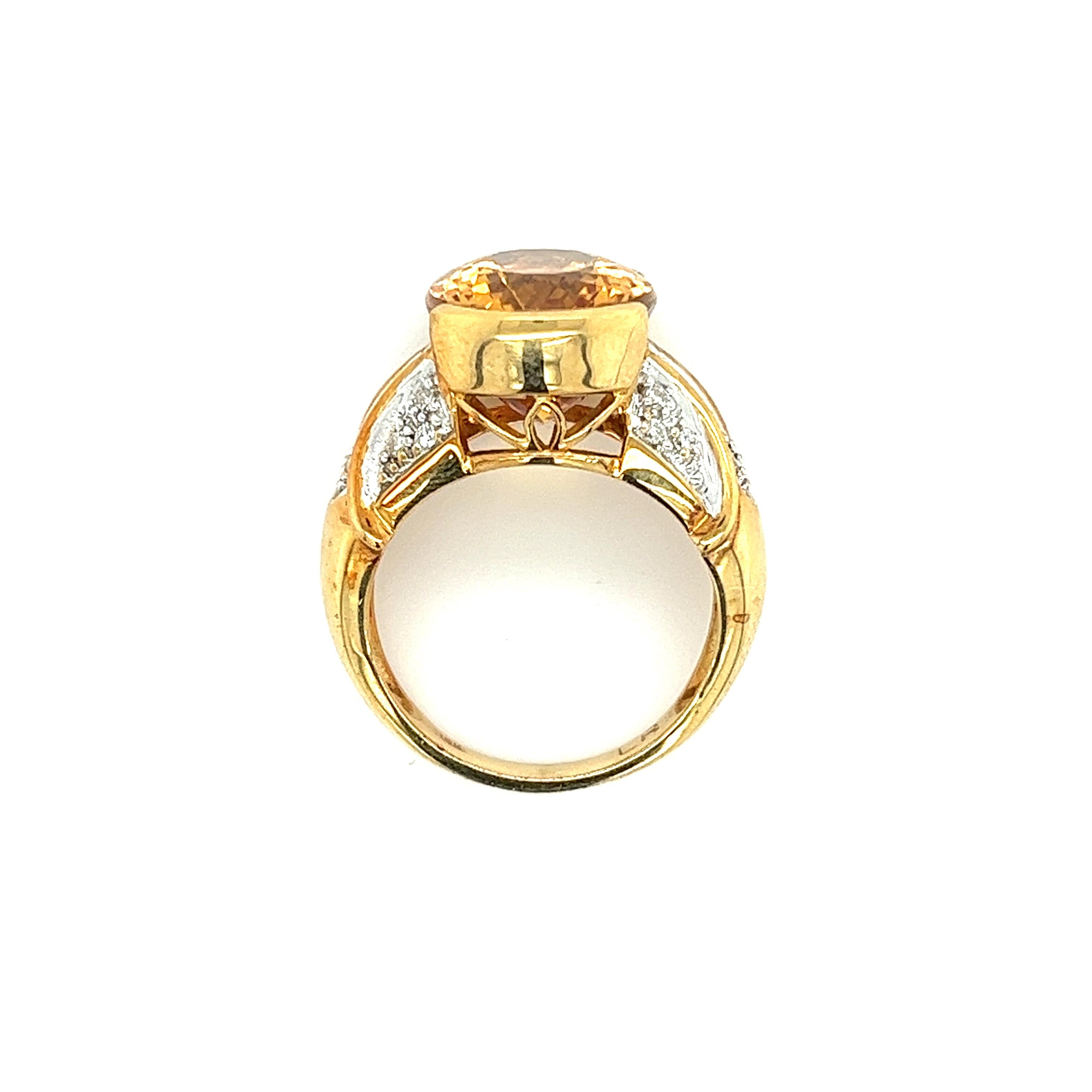 Vintage semi precious gemstone ring boasting an oval cut yellow topaz center stone, featuring round cut diamond side stones. All secured through a bezel and prong set 18k yellow and white gold mounting. The ring bears a wide frame, heavy weight, and