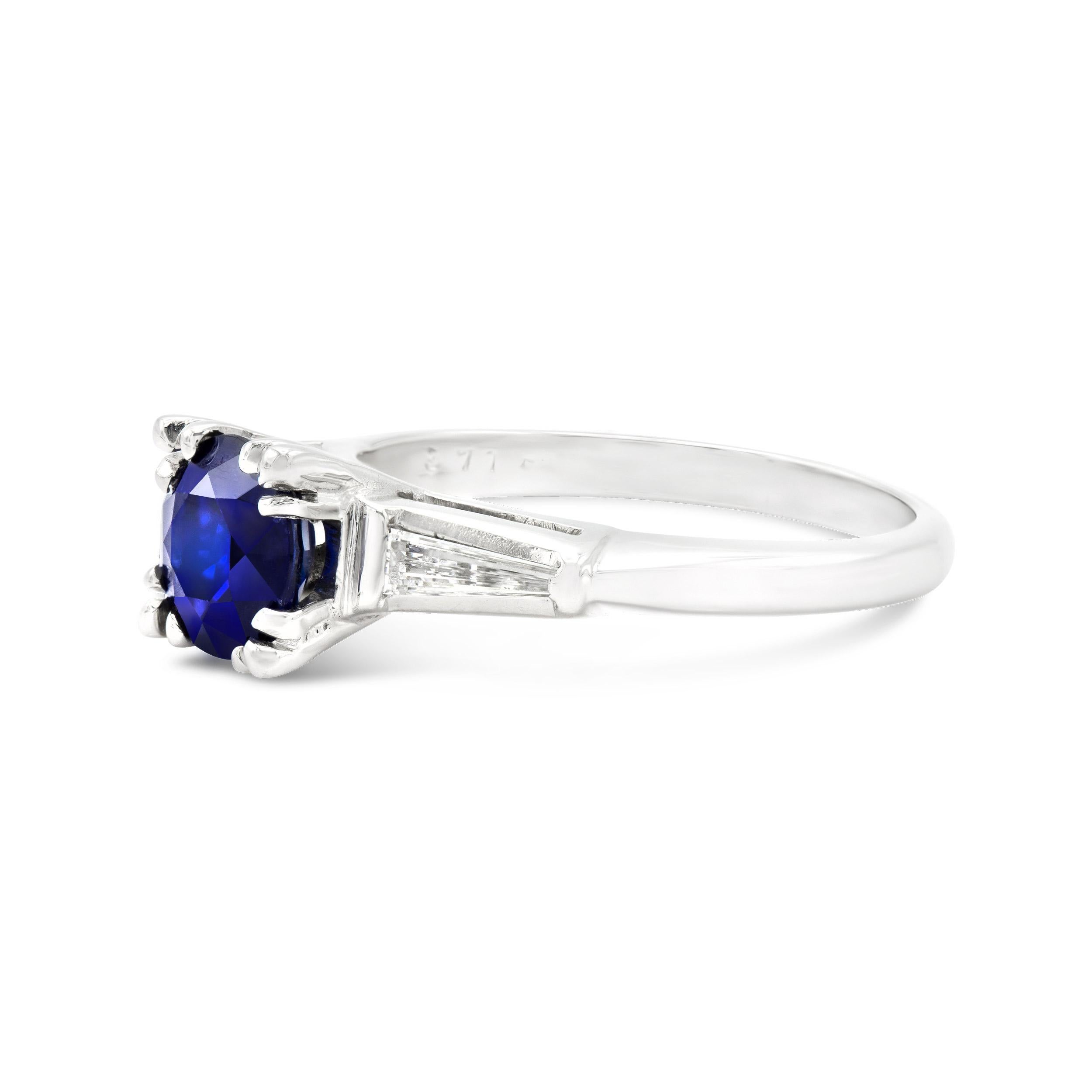This ring is just how we like it, with a twist. This vintage engagement ring hosts a beautiful 1.05 carat natural sapphire. It's deeply hued and sits sweetly between two super slender tapered baguettes. We love the modern feel of this vintage