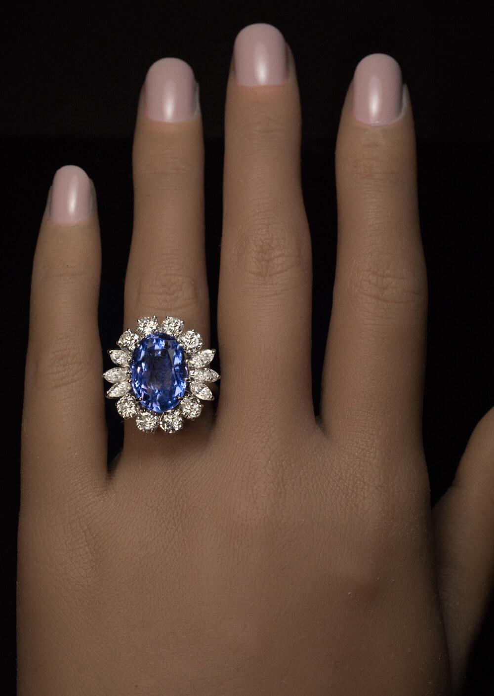 The ring is crafted in 14K white gold. It features an excellent natural unheated 10.66 ct blue sapphire from Ceylon. The sapphire is surrounded by eight round and six marquise cut diamonds (F-G color, VS1-VS2 clarity).
Estimated total diamond weight