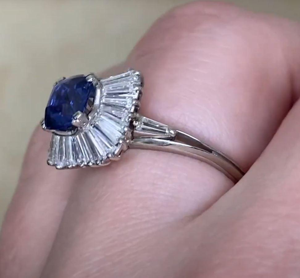 This exquisite vintage ballerina-style engagement ring showcases a stunning approx. 1.00-carat cushion-cut sapphire at its center, prong-set to enhance its brilliance. The deep blue sapphire is elegantly framed by a halo of meticulously arranged