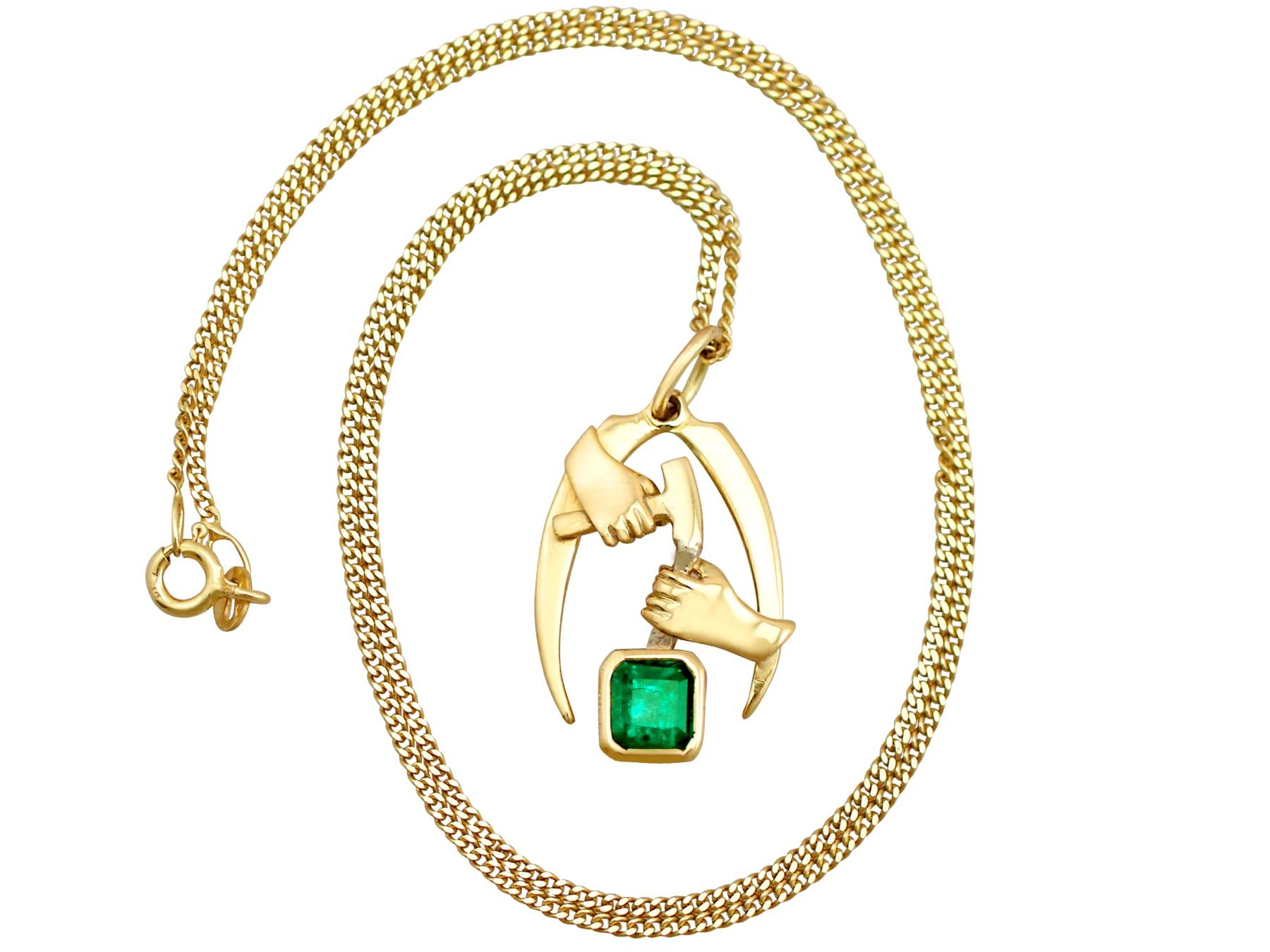 A fine and impressive vintage 1.07 carat natural emerald, 18 karat yellow gold 'artisan' pendant; part of our diverse vintage jewelry collection.

This unique necklace has been crafted in 18k yellow gold.

The unusual pendant depicts two hands