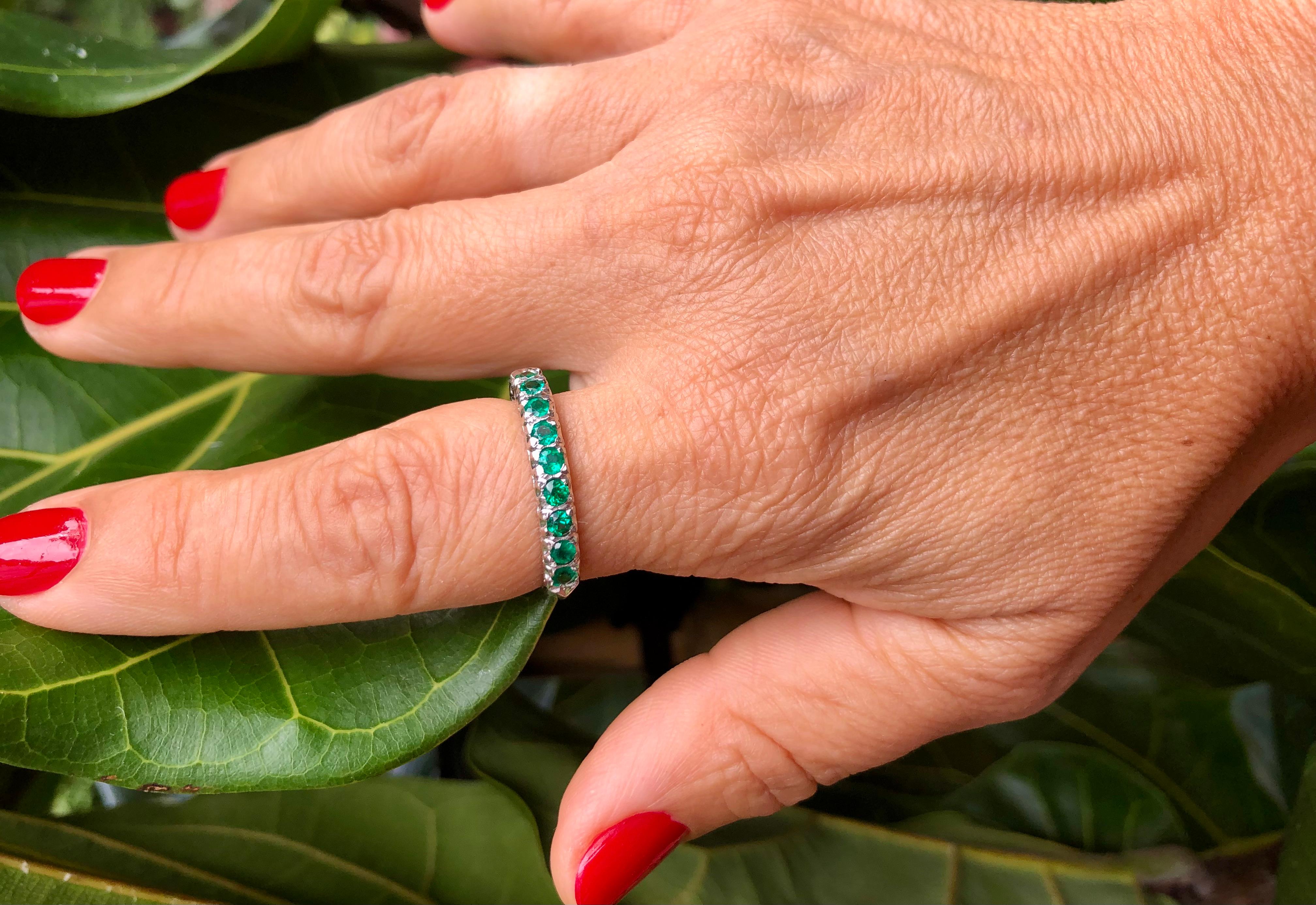 A classic and fashionable vintage Colombian emerald Anniversary, engagement, or stackable band ring showcasing a row of round-cut with 10 Natural Colombian. Excellent color and clarity Colombian natural emeralds, set in a wedding band Platinum. The