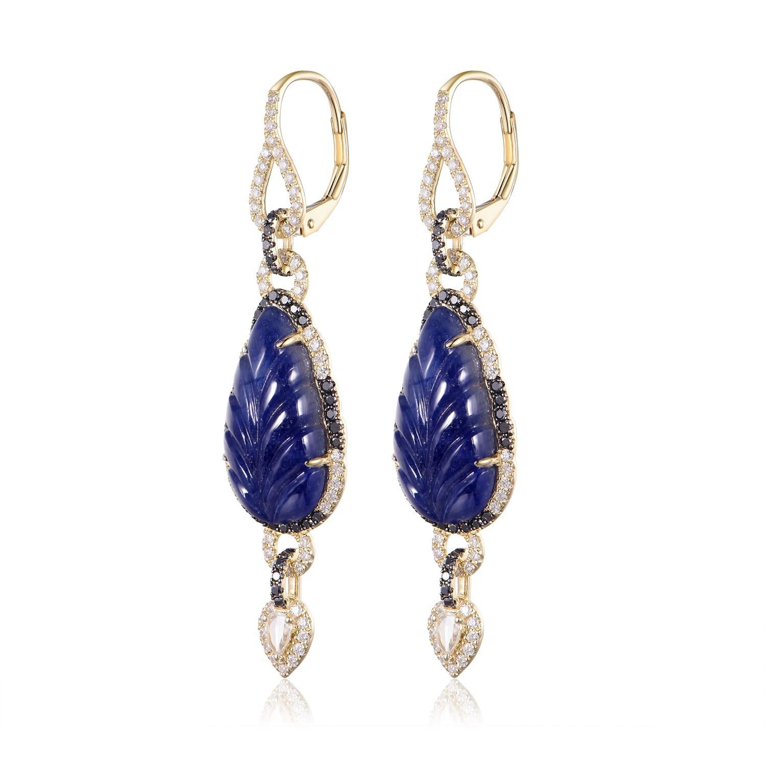 Unveil the essence of sophistication with these captivating earrings, each graced with a masterfully carved leaf-shaped sapphire, totaling a remarkable 16.62 carats for the pair. The sapphires exude a rich, velvety blue, encapsulating the depth of a