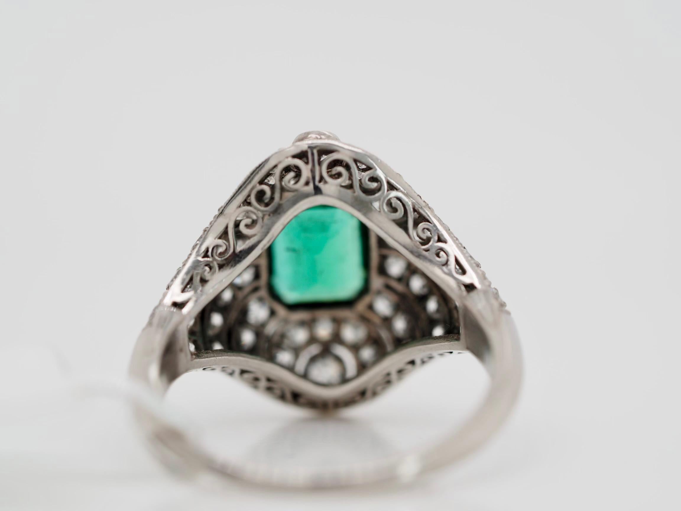 This stunning vintage one of a kind ring, is a must have for cocktail's. It has a beautiful natural emerald, that brings this ring together. Enhanced with diamonds surrounding the emerald, following the intricate pattern. You will not see this ring