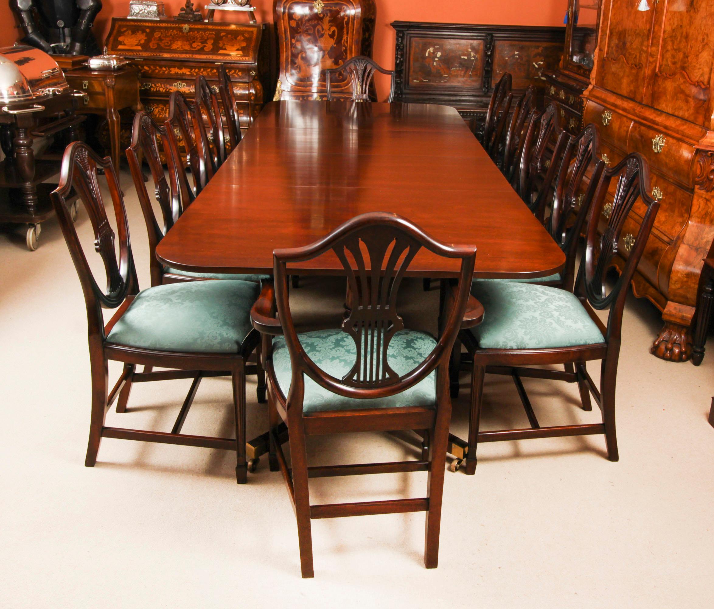 This is  fabulous Vintage dining set comprising a Regency Revival dining table and a set of twelve Wheatsheaf Shieldback  dining chairs, by the master cabinet maker William Tillman, Circa 1980 in date.

The table is made of stunning solid flame