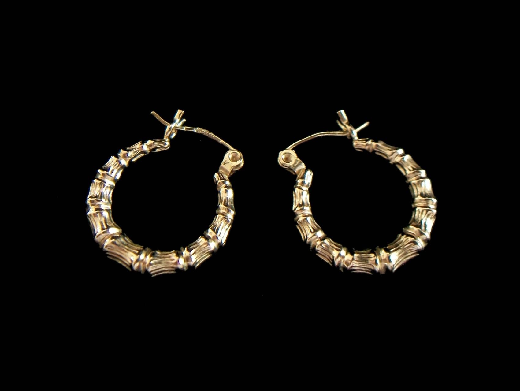 Vintage 10K yellow gold faux bamboo hoop earrings for pierced ears - stamped 10K and signed on the back ('N' within a diamond - unknown/unidentified maker) - United States (likely) - circa 1980's.

Excellent vintage condition - all original - no