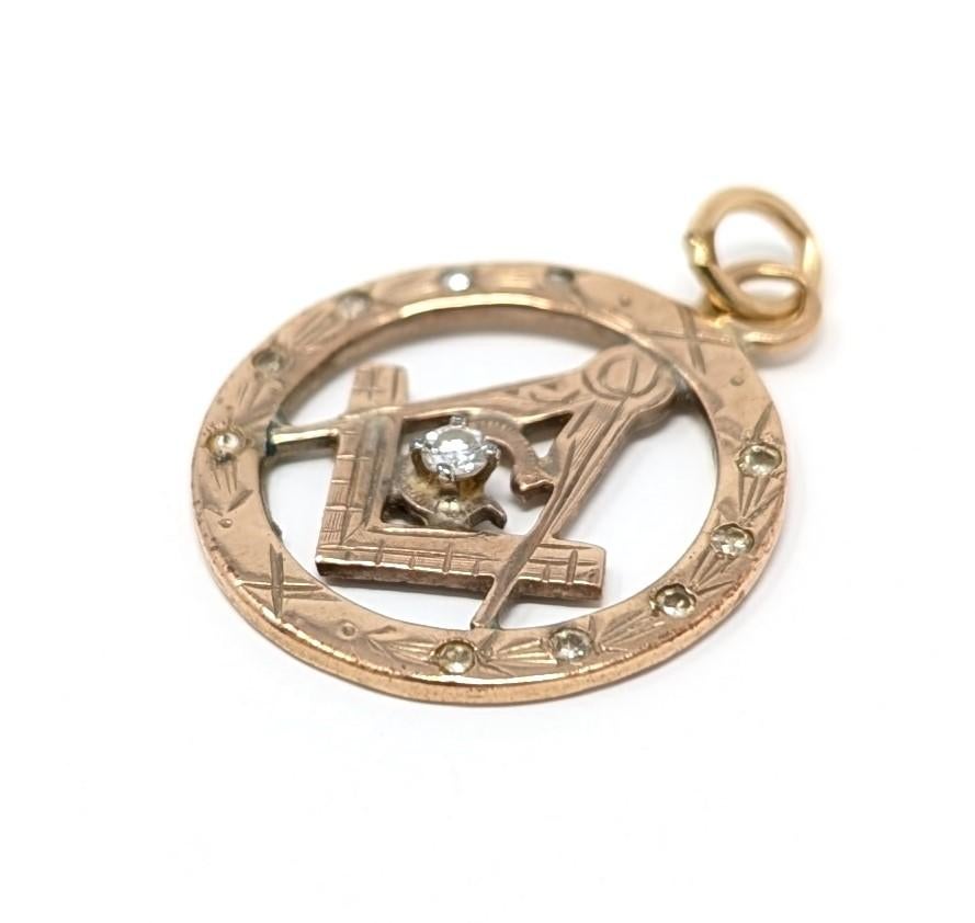 Vintage 10k solid yellow gold masonic pendant featuring a dazzling diamond centerpiece with smaller diamond accents on each side. Signed / stamped 