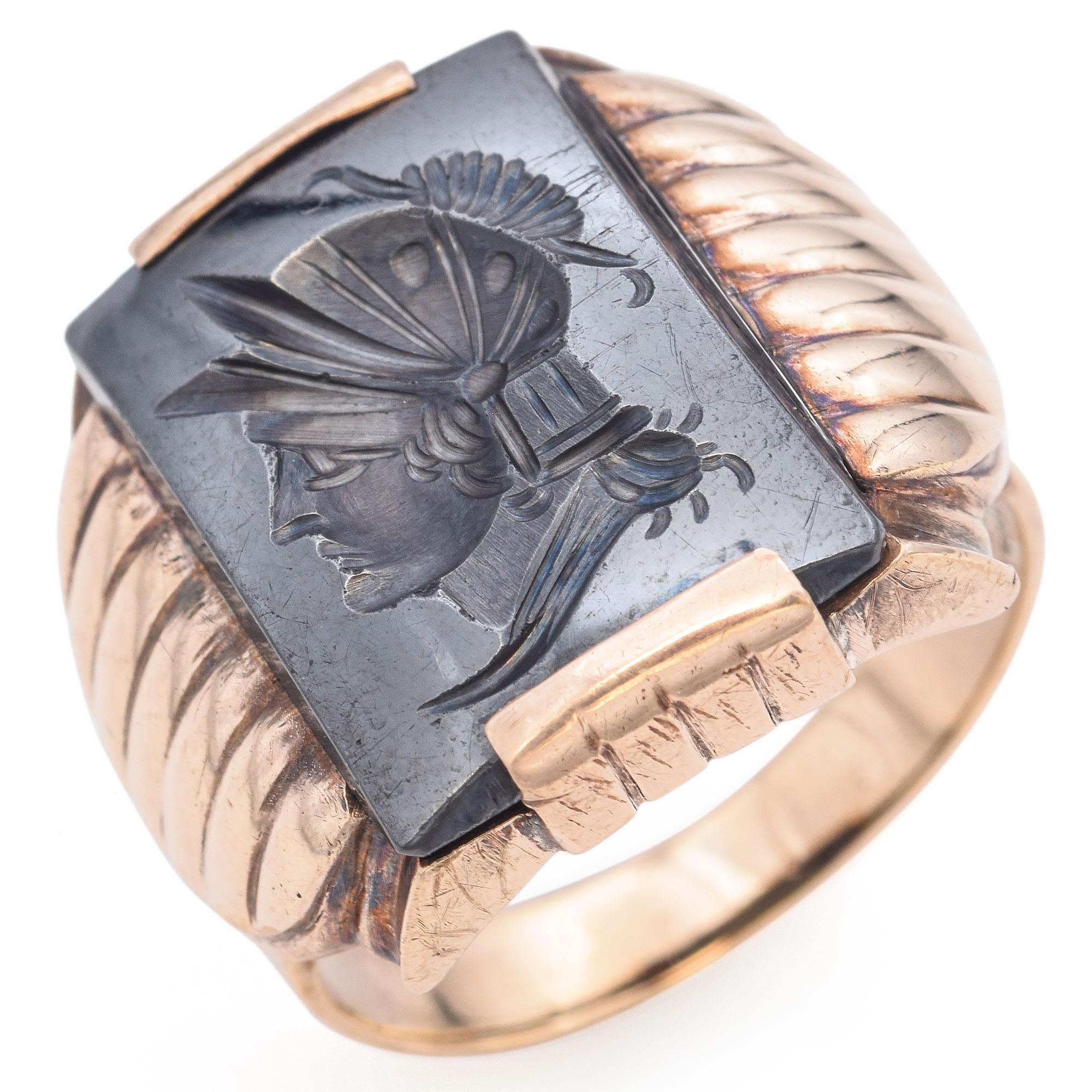 This remarkable piece features a bold design crafted in 10k yellow gold. The centerpiece is an engraved intaglio depicting a profile of a warrior, set within a rectangular frame. The intricate detailing of the helmet and facial features adds depth