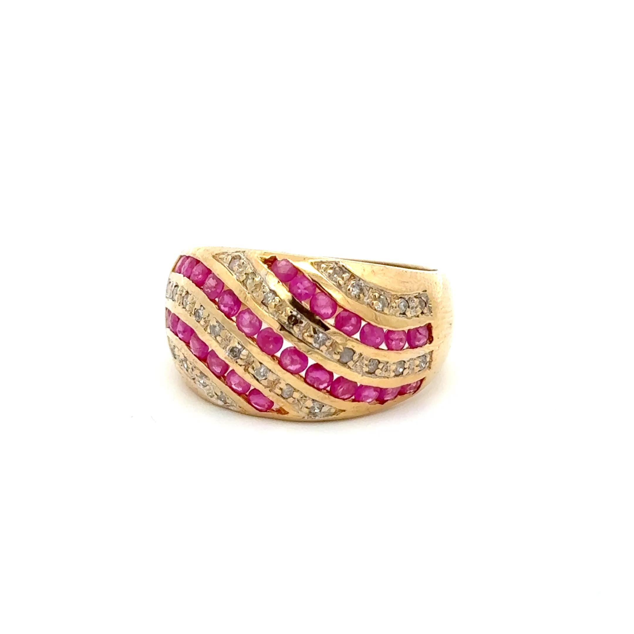 A bold expression of vintage luxury, this stunning 10K yellow gold ring showcases an elegant wave design set with alternating rows of vibrant natural rubies (1.05 carats) and shimmering round-cut diamonds (0.75 carats). The richly saturated rubies