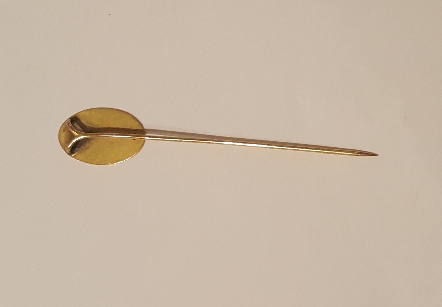 Vintage 10kt yellow gold stickpin by Designer Harry S Bick. The 3/4 inch oval at the top of the pin appears to have monogram lettering, however, it appears as a scroll design. Weighs 1.6 grams. This lovely vintage stickpin could be used on a lapel,