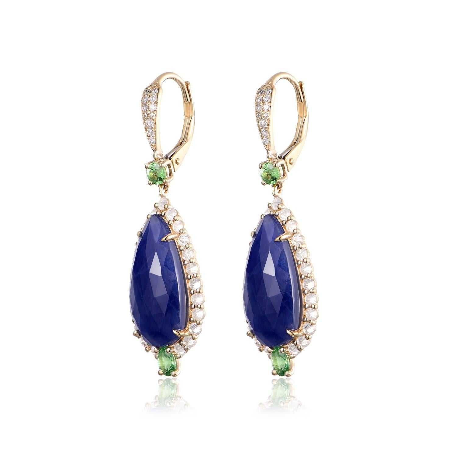 Indulge in the opulence of these stunning drop earrings, each featuring a mesmerizing 5.435-carat pear-shaped sapphire, sumptuously weighted at 10.87 carats for the pair. These magnificent blue gems are framed by an innovative halo of natts