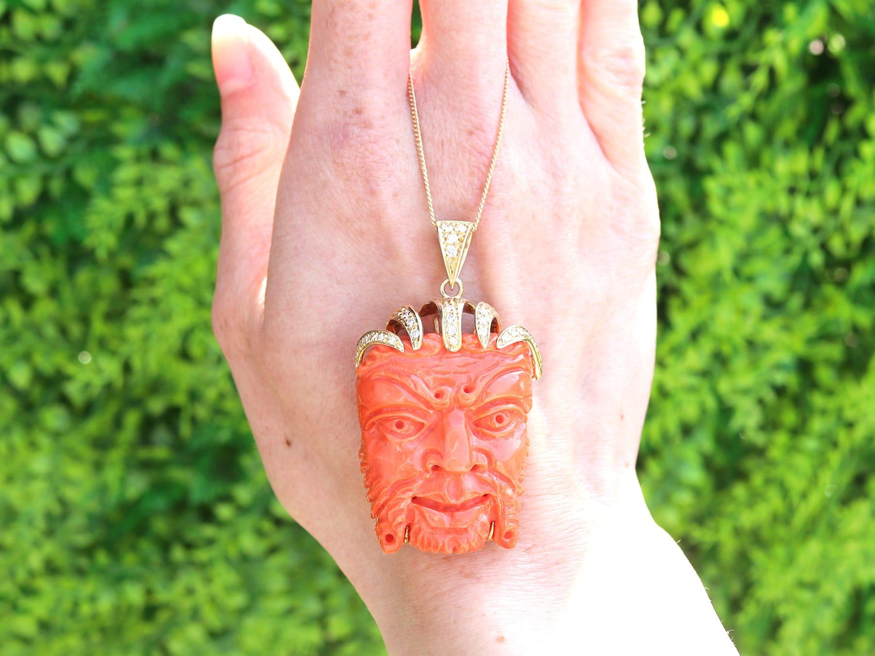 A stunning, fine and impressive vintage 112 carat coral and 0.29 carat diamond, 18 karat yellow gold grotesque mask pendant; part of our diverse vintage jewellery and estate jewelry collections.

This fine and impressive vintage pendant has been