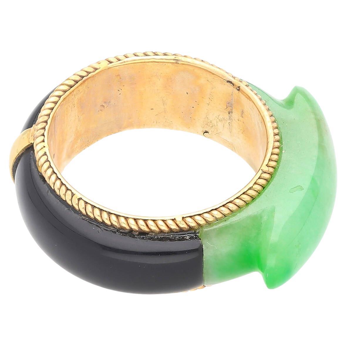 14K Yellow Gold Ring weighing 5.97 grams. The ring boasts a remarkable 11.40-carat carved Jade, exhibiting an enchanting green hue that exudes natural beauty. Complementing the Jade, the ring features an Onyx band that adds contrast and