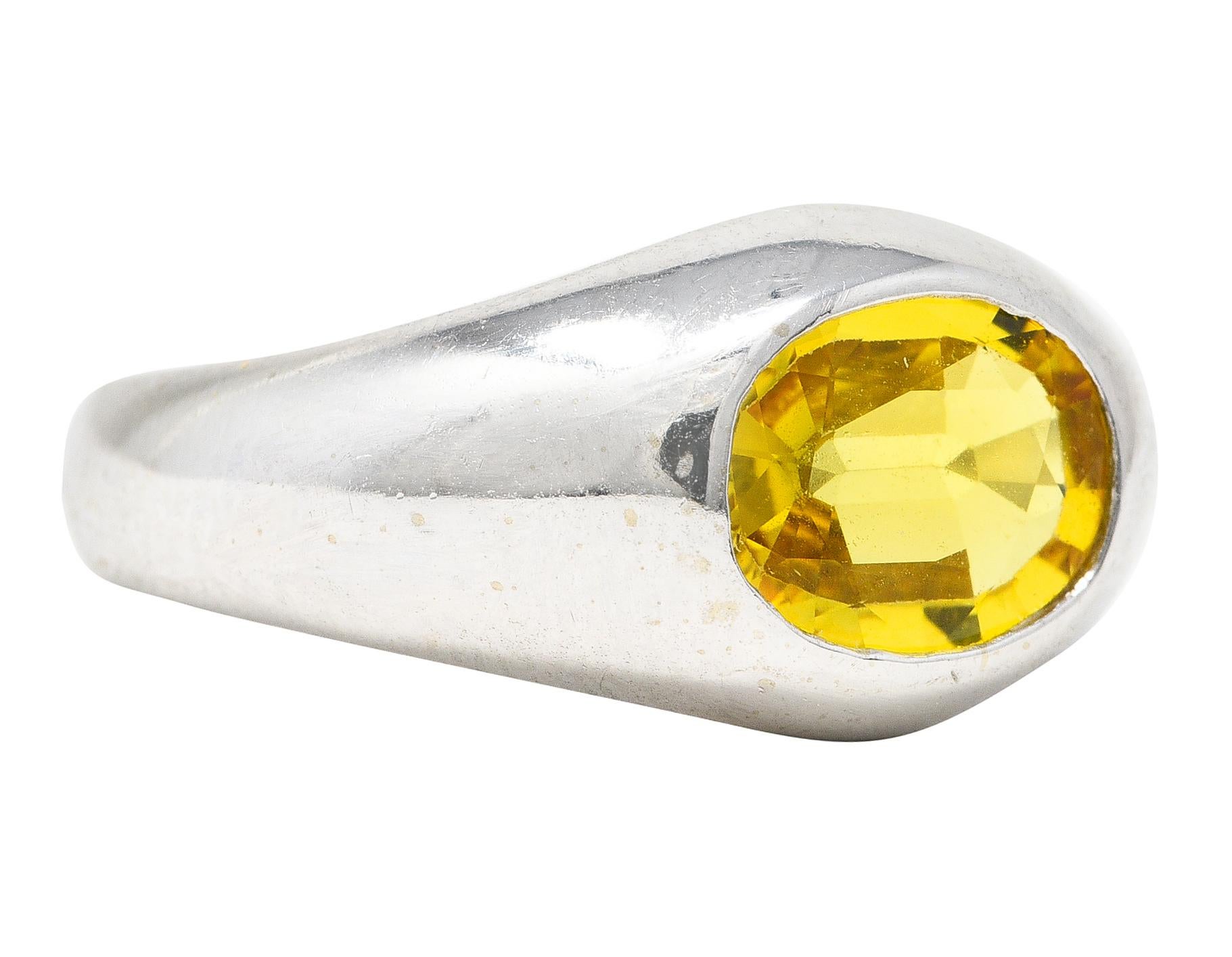 Gypsy style bombé band ring features a mixed oval cut sapphire. Flushly set East to West. While weighing approximately 1.15 carats. Transparent with vivid yellow color. Stamped 14K for 14 karat gold. Circa late 20th century. Ring Size: 6 3/4 &