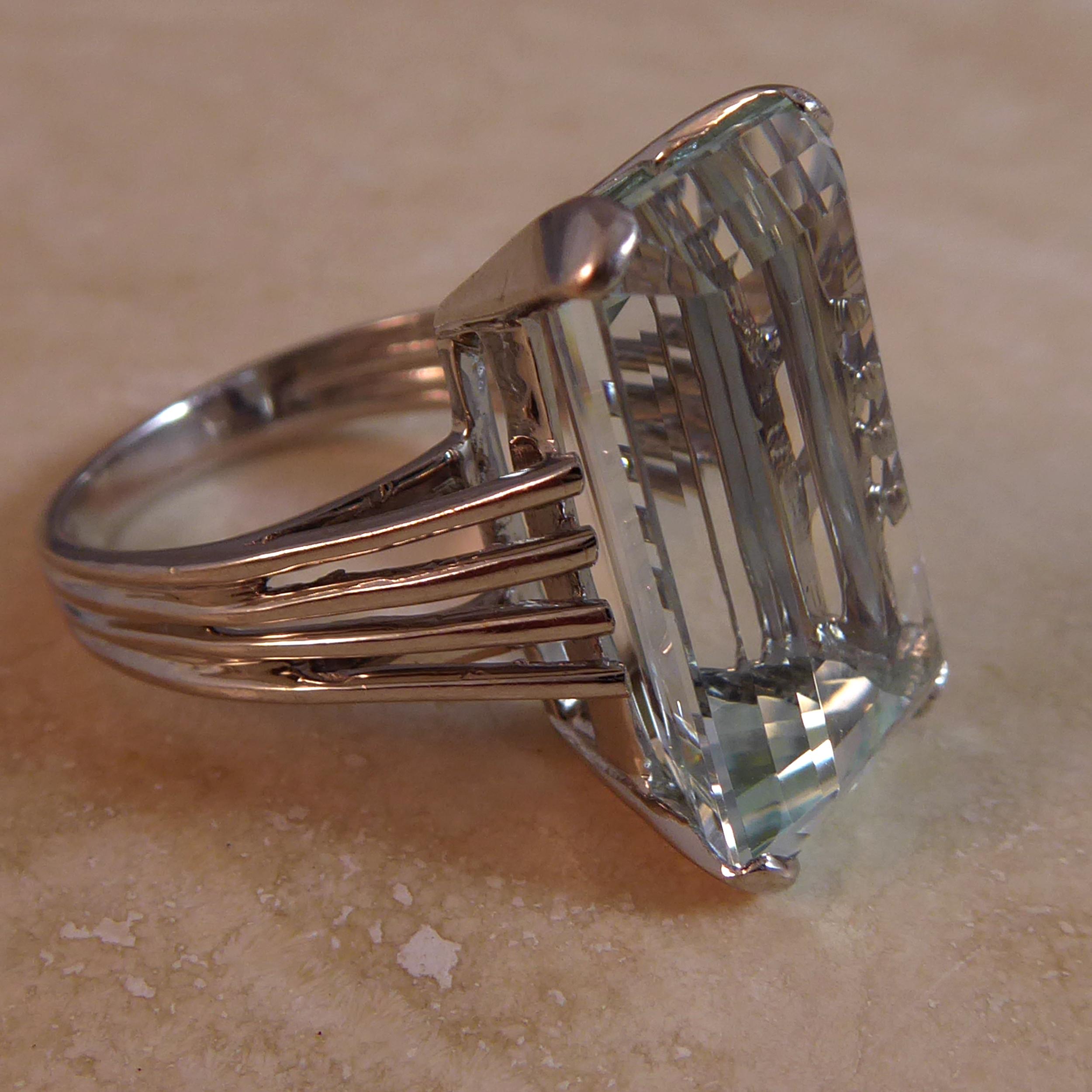 At 11.50 carat, this spectacular vintage aquamarine ring needs no other embellishment.  The rectangular cut cornered, step cut gemstone is held in white gold four corner claw setting allowing the beauty of the gemstone to shine through unhindered by